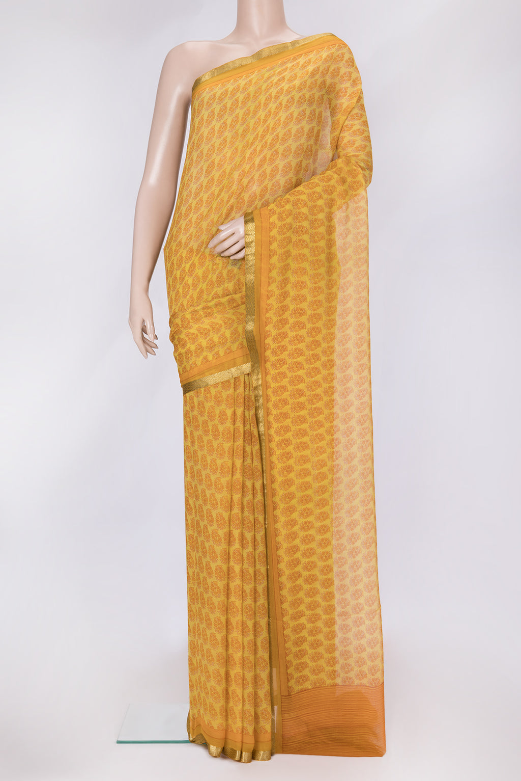 Mustard Dual Tone Mysore Chiffon Saree with Printed design on the body and Zari Border.  displayed on a mannequin