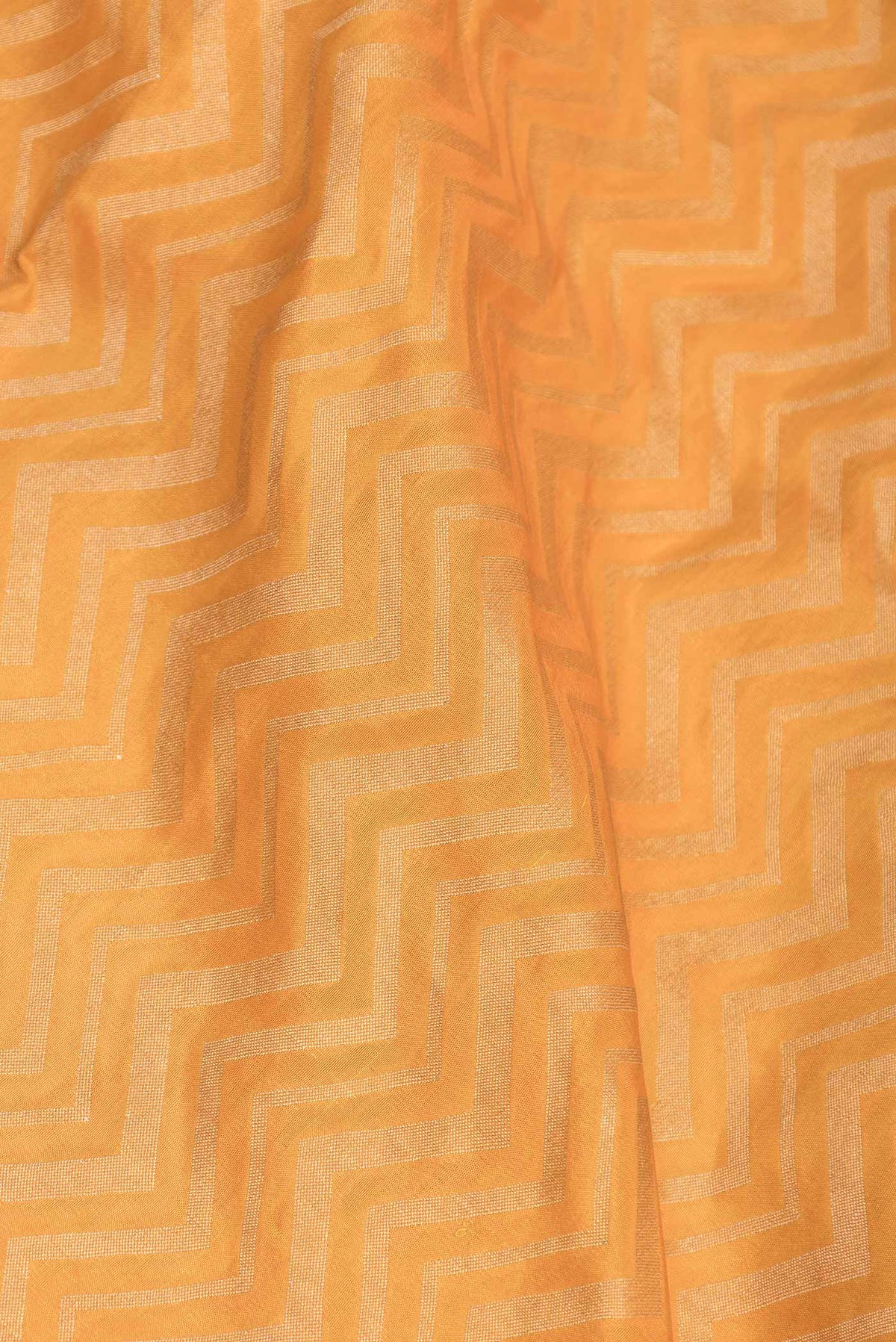 Close up of Orange Dual Tone Banarasi Saree with Zari Brocade on the body and Zari Border displaying folds