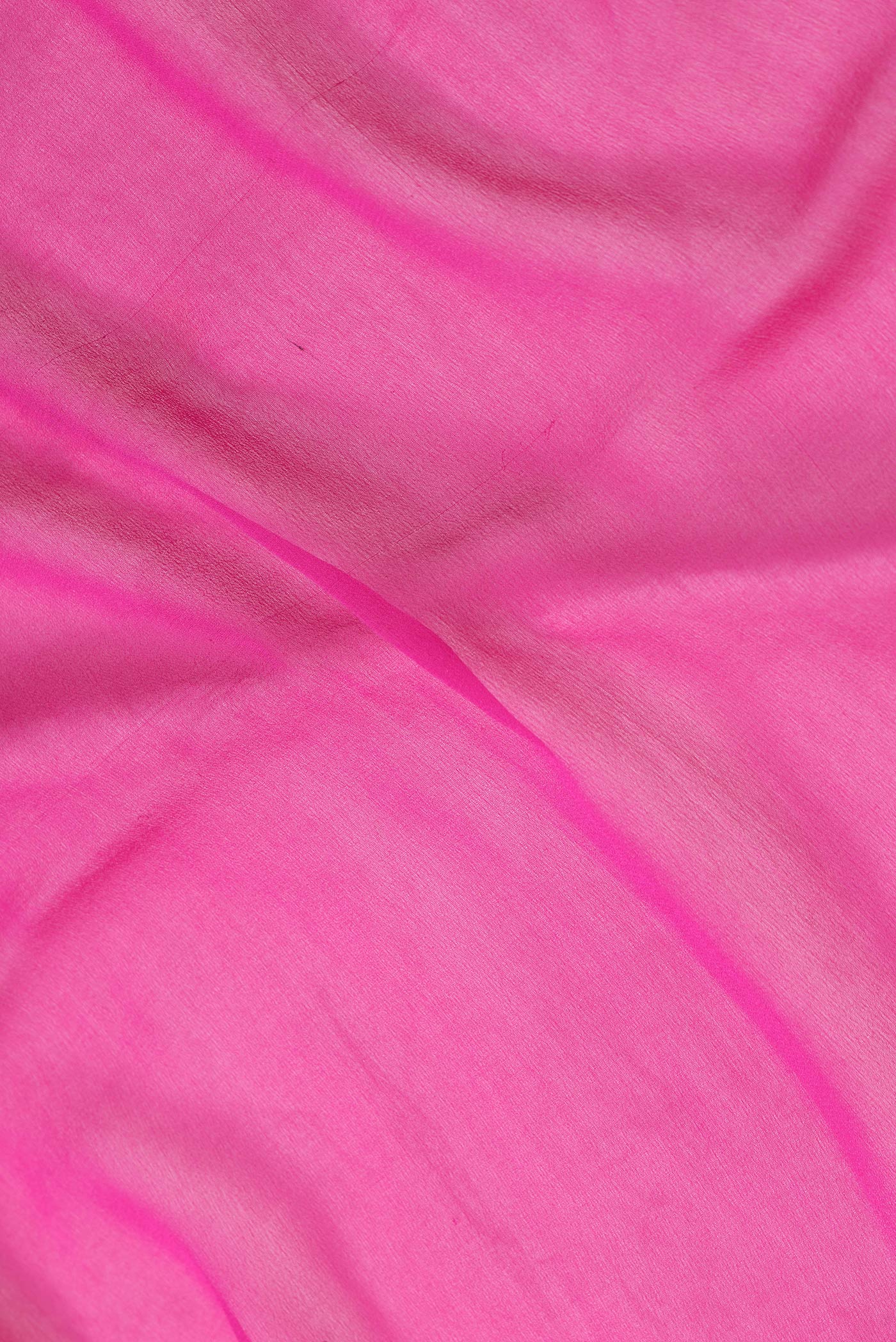 Close up of Pink Dual Tone Mysore Georgette Saree with Plain Body and Zari Border.  displaying folds