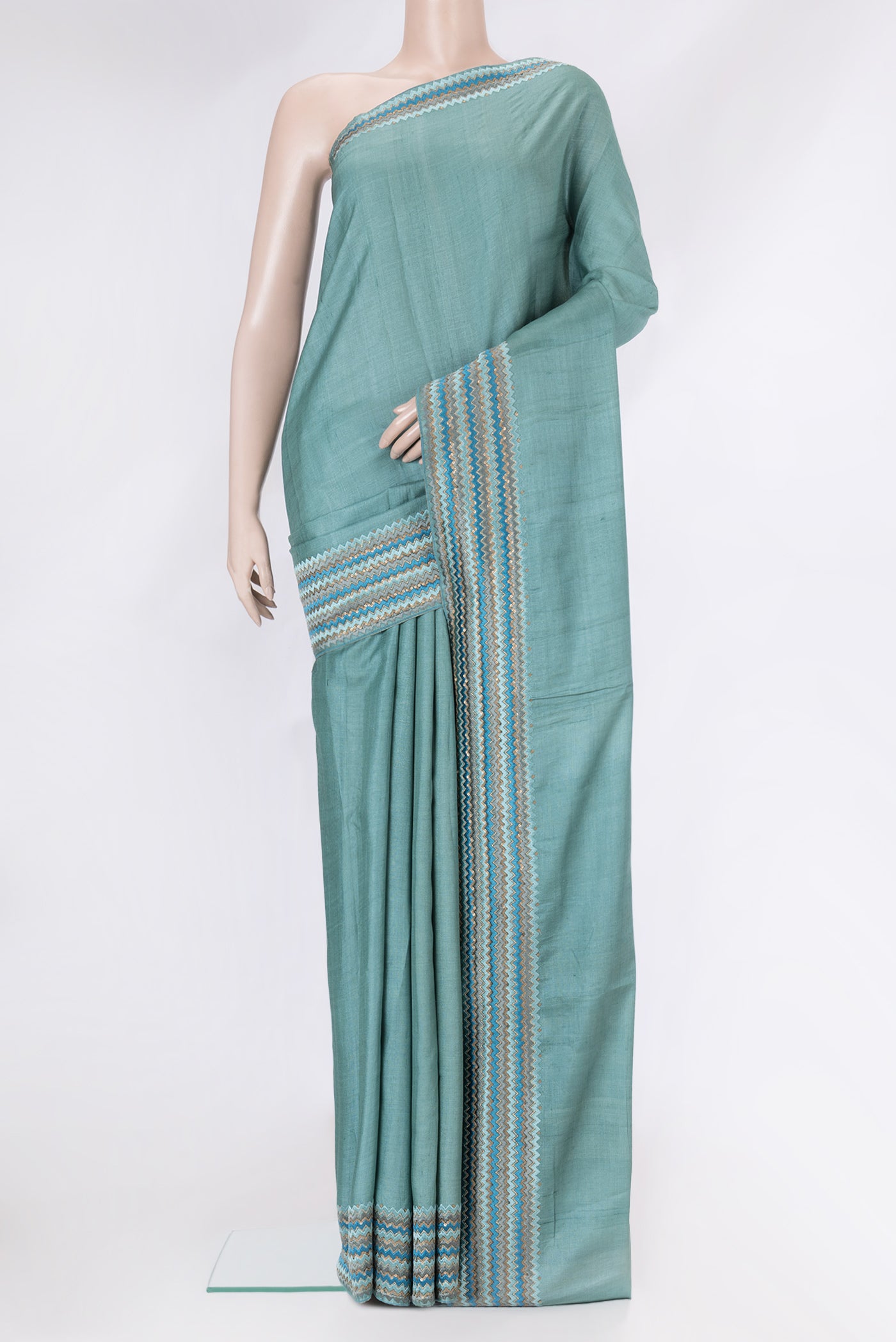 Grey Dual Tone Tussar Silk Saree with Plain Body and Embroidery Border.  displayed on a mannequin