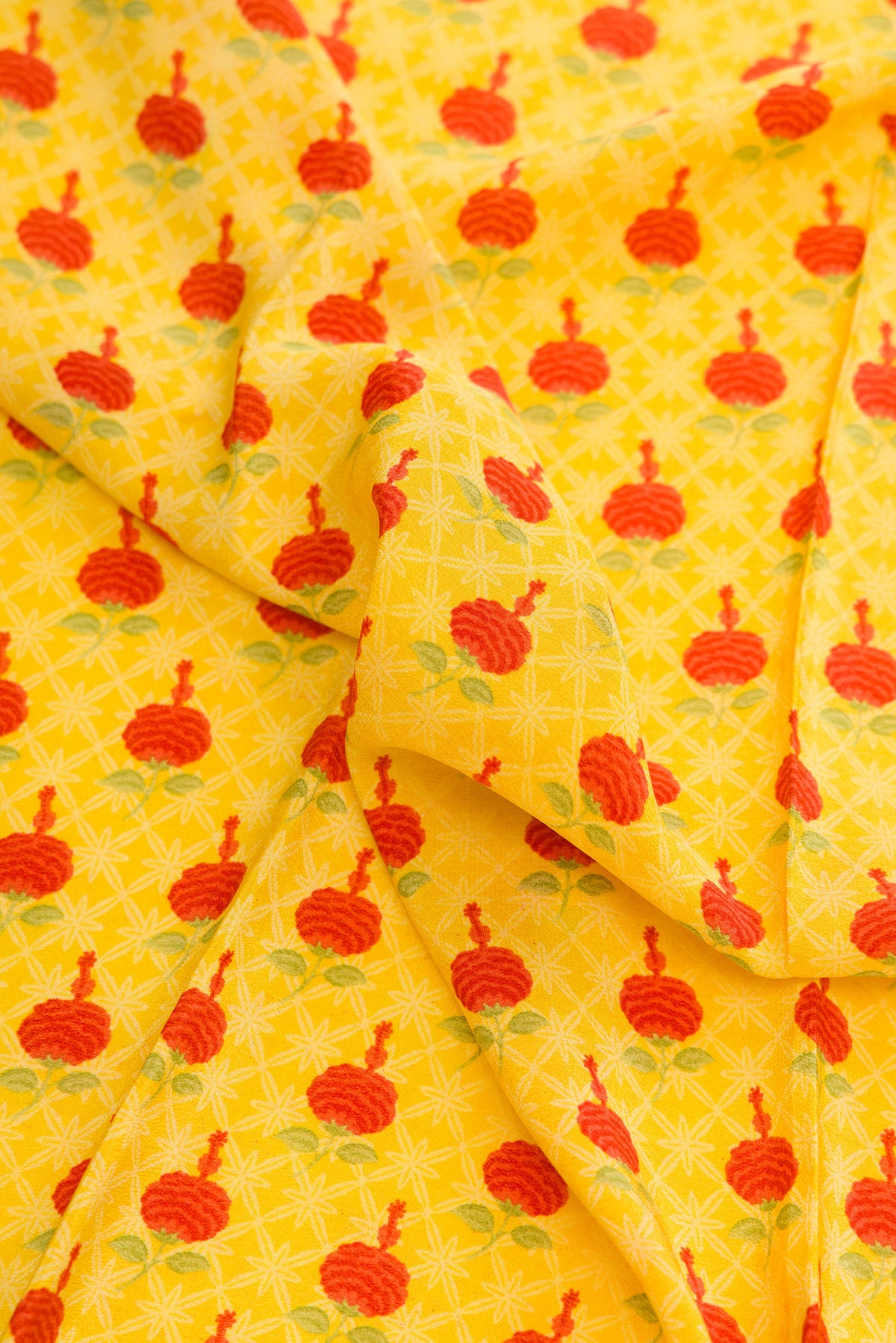Close up of Yellow Dual Tone Mysore Crepe Saree with Printed design on the body and Printed Border.  displaying folds