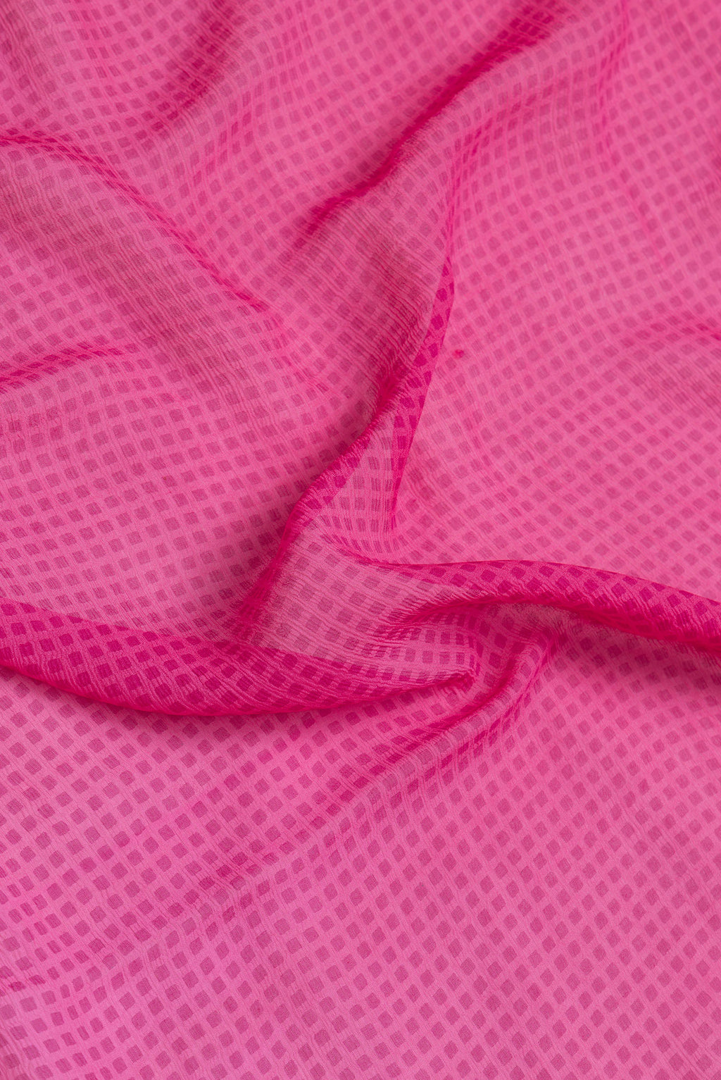 Close up of Pink Dual Tone Mysore Georgette Saree with Printed design on the body and Printed Border.  displaying folds