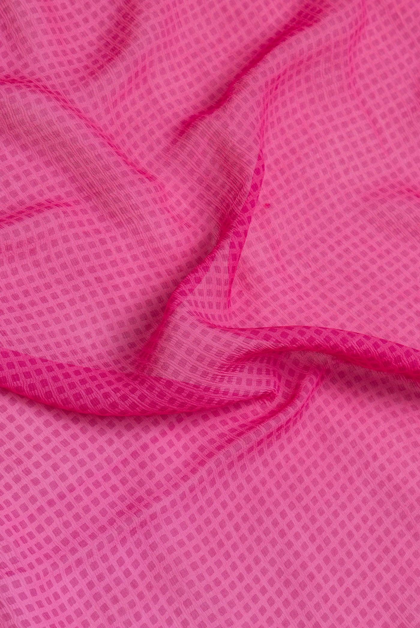 Close up of Pink Dual Tone Mysore Georgette Saree with Printed design on the body and Printed Border.  displaying folds