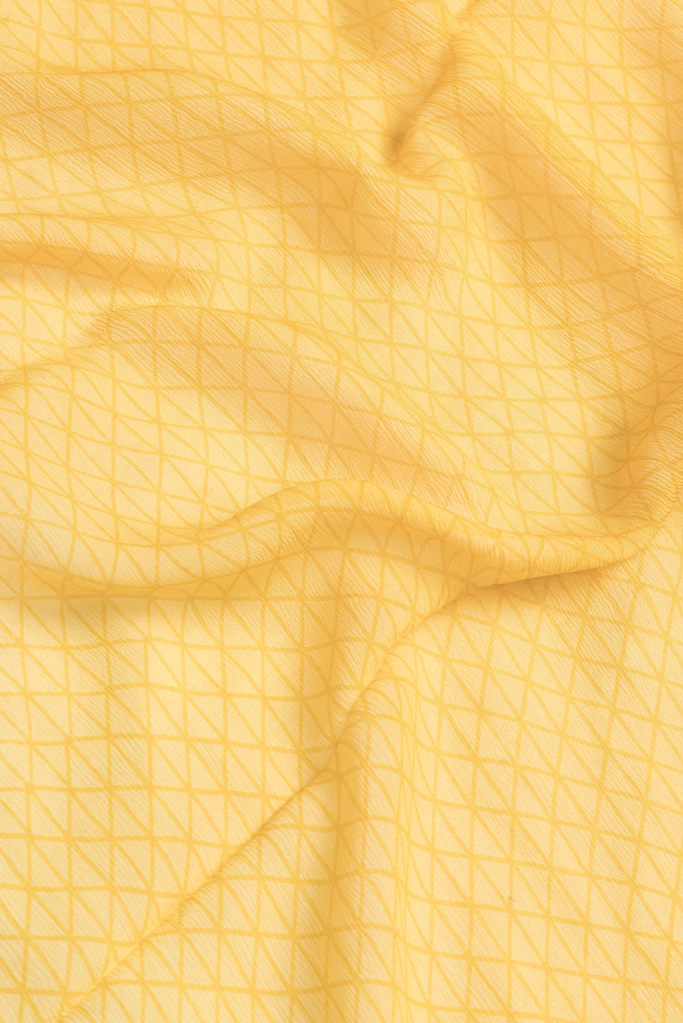 Close up of Mustard Dual Tone Mysore Chiffon Saree with Printed design on the body and Fancy Border.  displaying folds