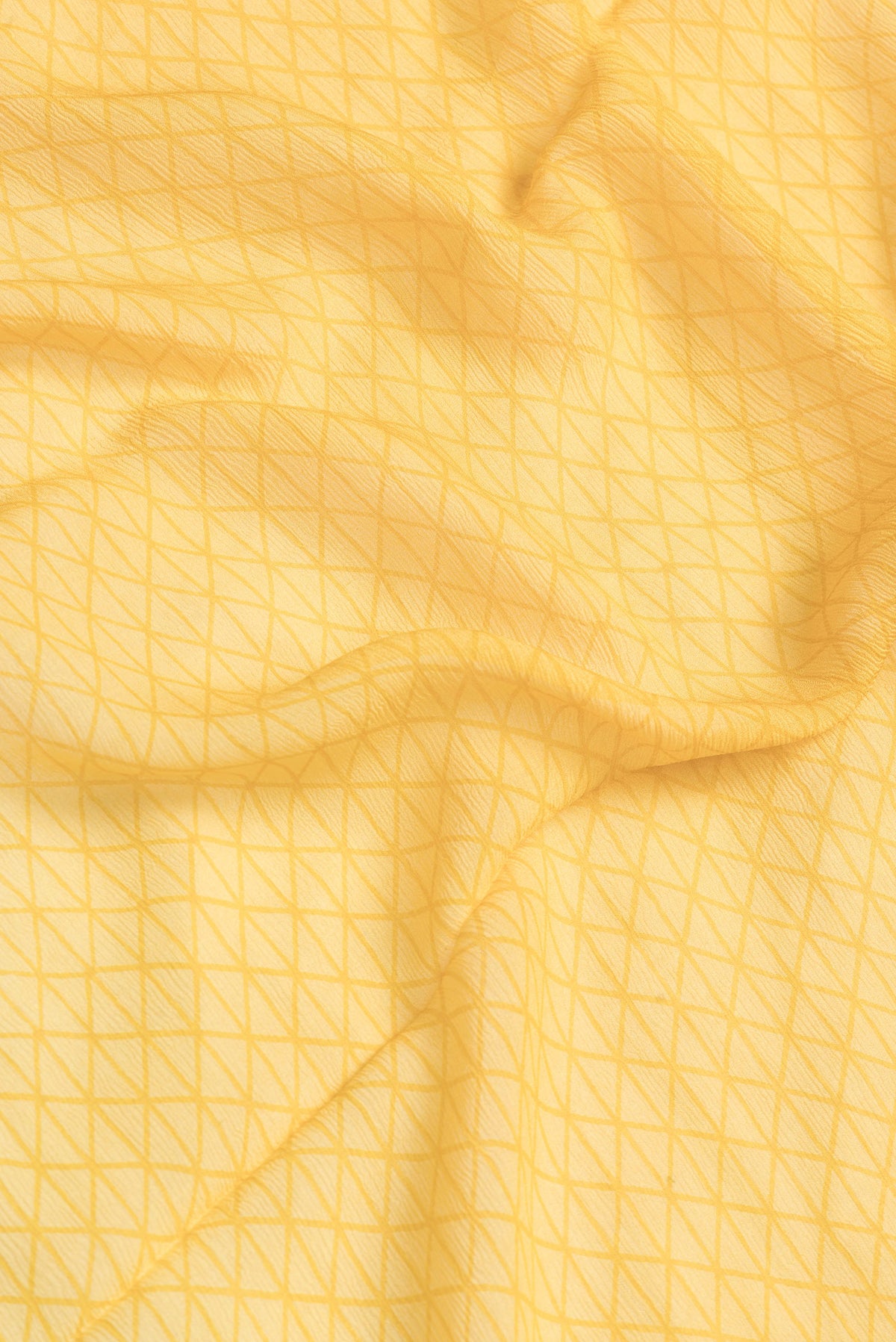 Close up of Mustard Dual Tone Mysore Chiffon Saree with Printed design on the body and Fancy Border.  displaying folds