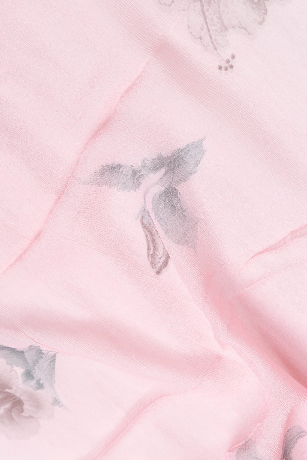 Close up of Pink Dual Tone Chiffon Saree with Printed design on the body and Zari Border.  displaying folds