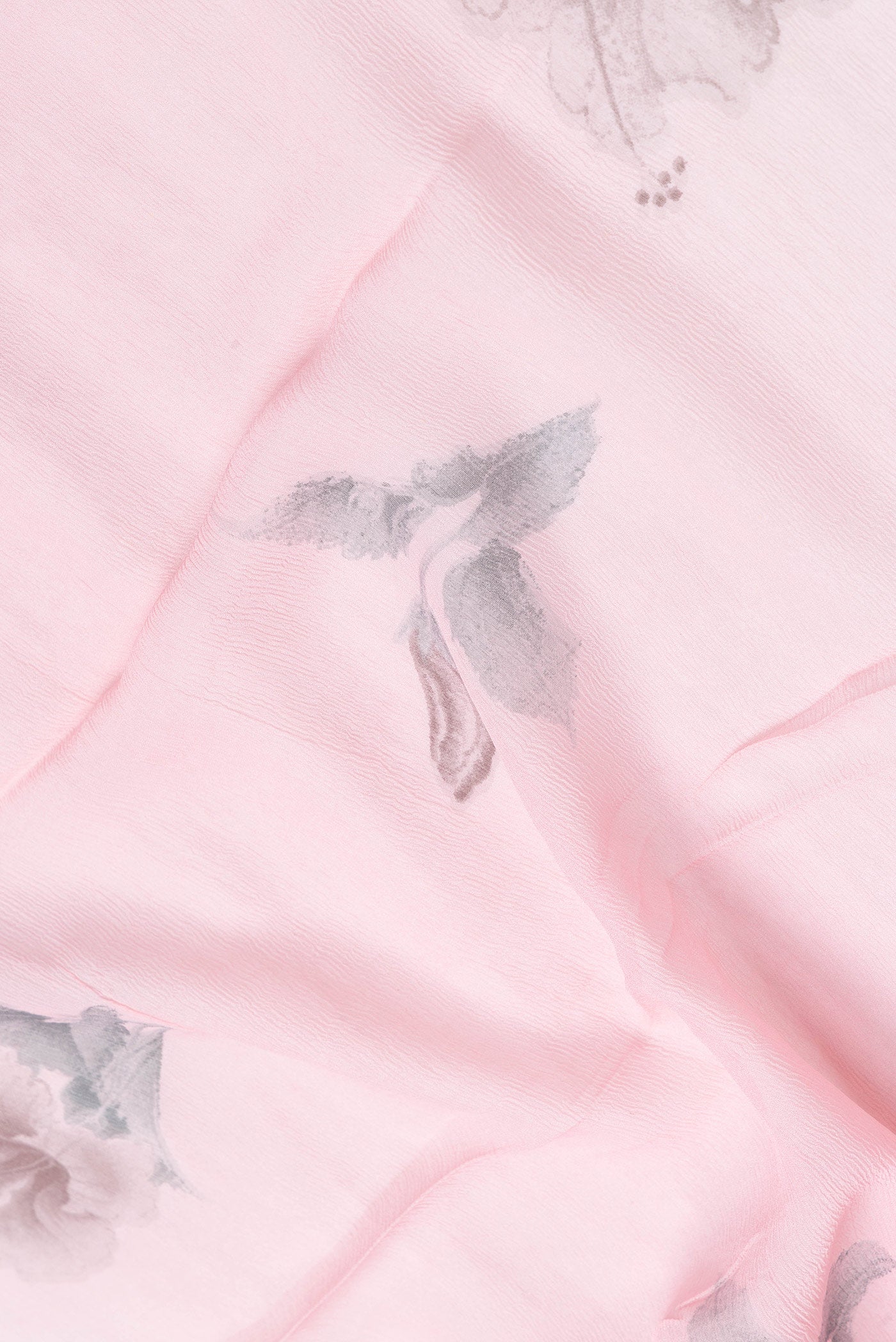 Close up of Pink Dual Tone Chiffon Saree with Printed design on the body and Zari Border.  displaying folds