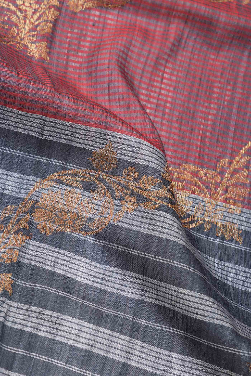 Close up of Grey Dual Tone Banarasi Silk Saree with Stripes on the body and Zari Border.  displaying folds