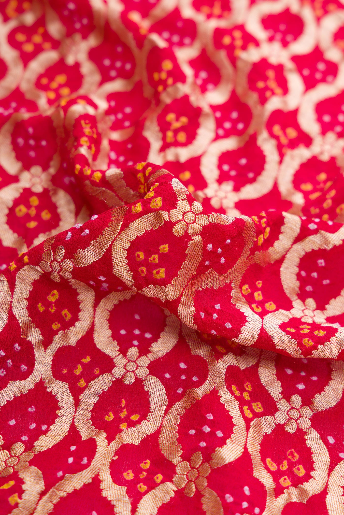 Close up of Red Dual Tone Banarasi Georgette Saree with Zari Brocade on the body and Fancy Border.  displaying folds