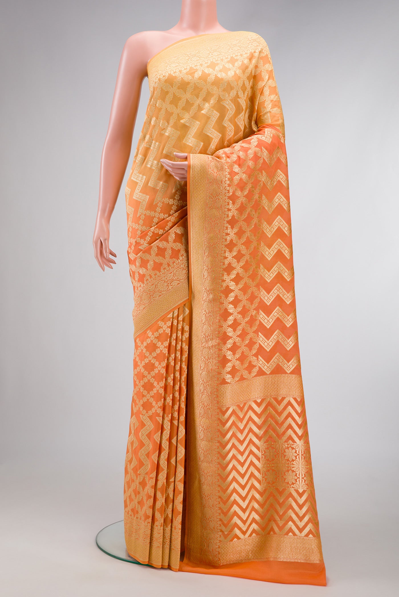 Orange Dual Tone Mysore Georgette Saree with Zari Brocade on the body and Zari Border.  displayed on a mannequin