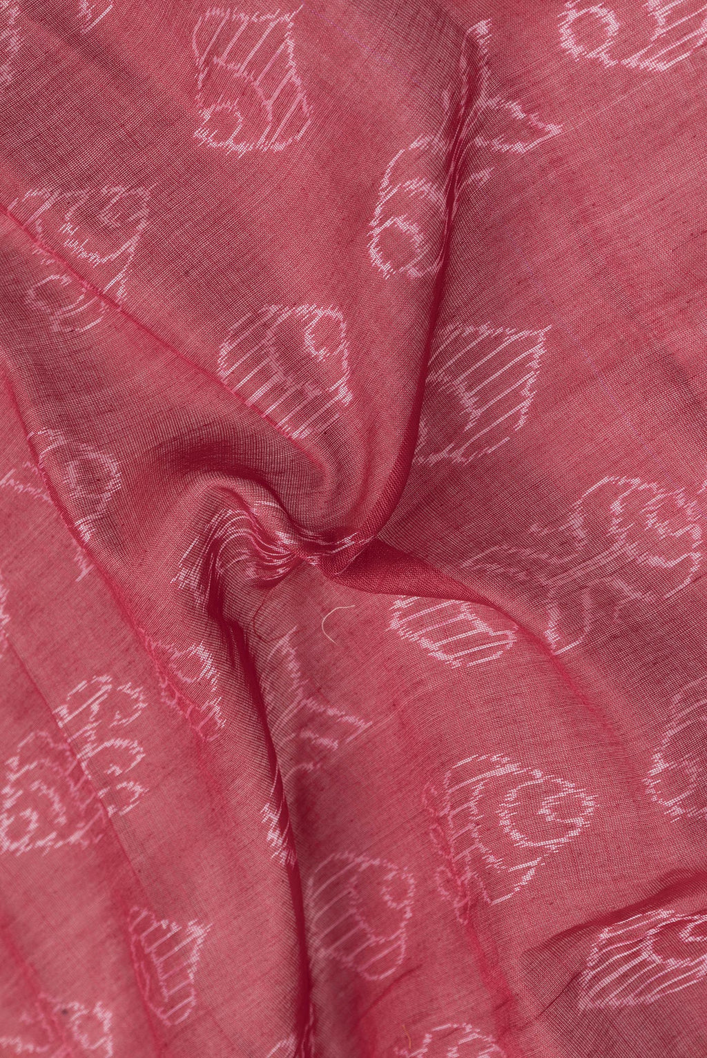 Close up of Deep Red Dual Tone Tussar Silk Saree with Printed design on the body and Ikat Border.  displaying folds
