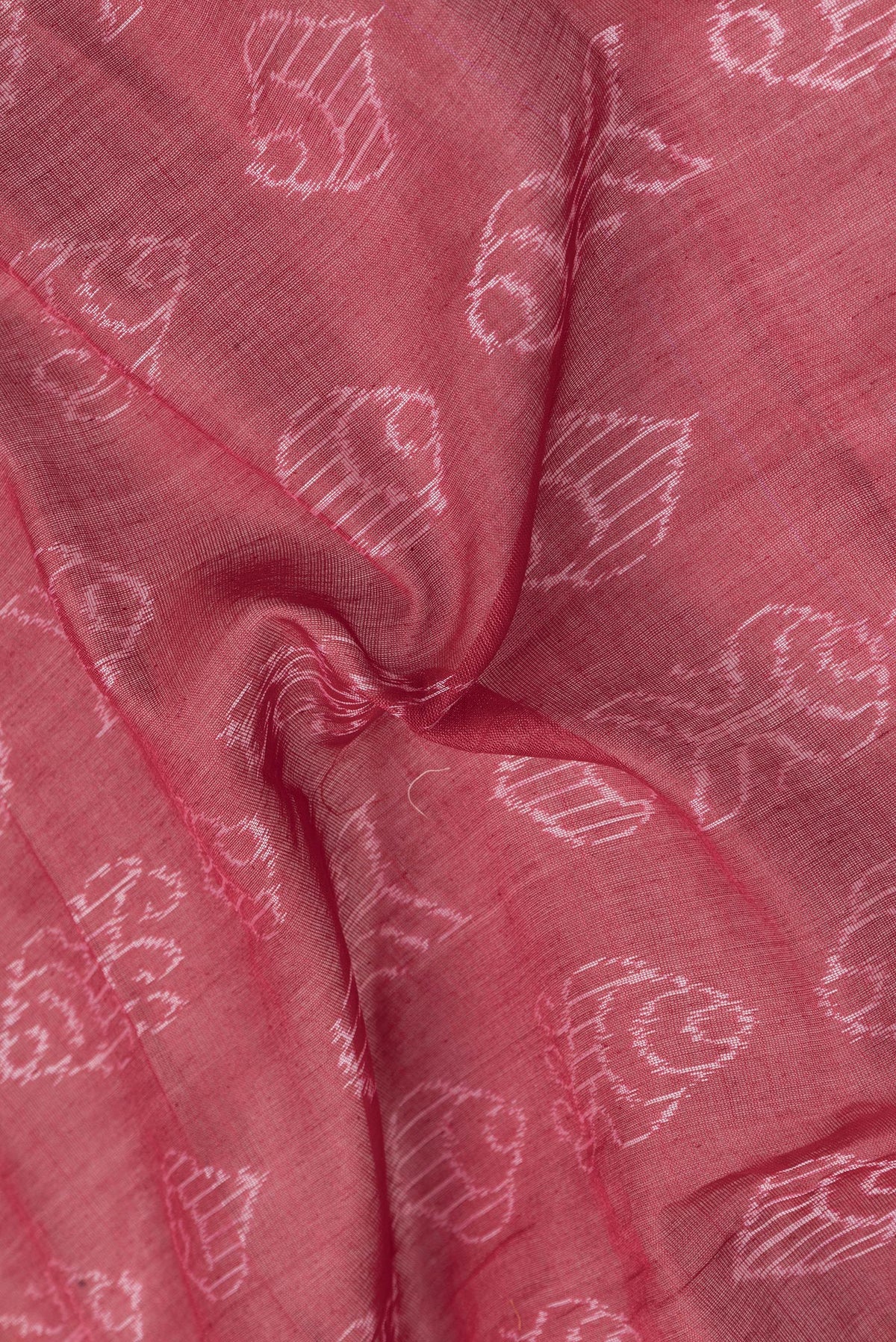 Close up of Deep Red Dual Tone Tussar Silk Saree with Printed design on the body and Ikat Border.  displaying folds