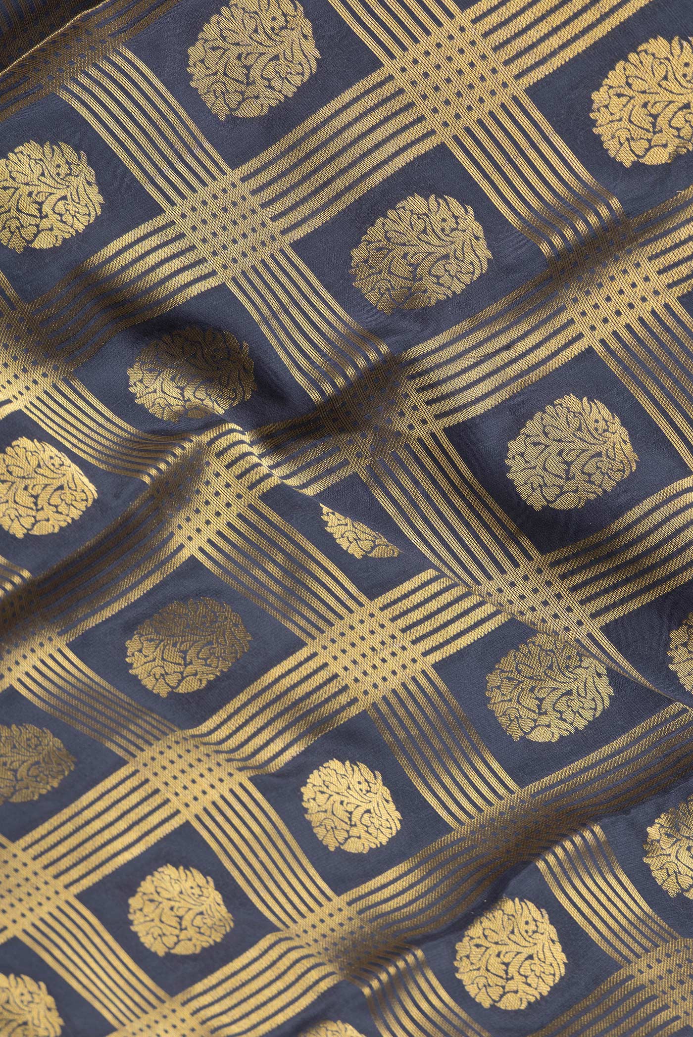 Close up of Grey Dual Tone Mysore Georgette Saree with Zari Brocade on the body and Zari Border.  displaying folds