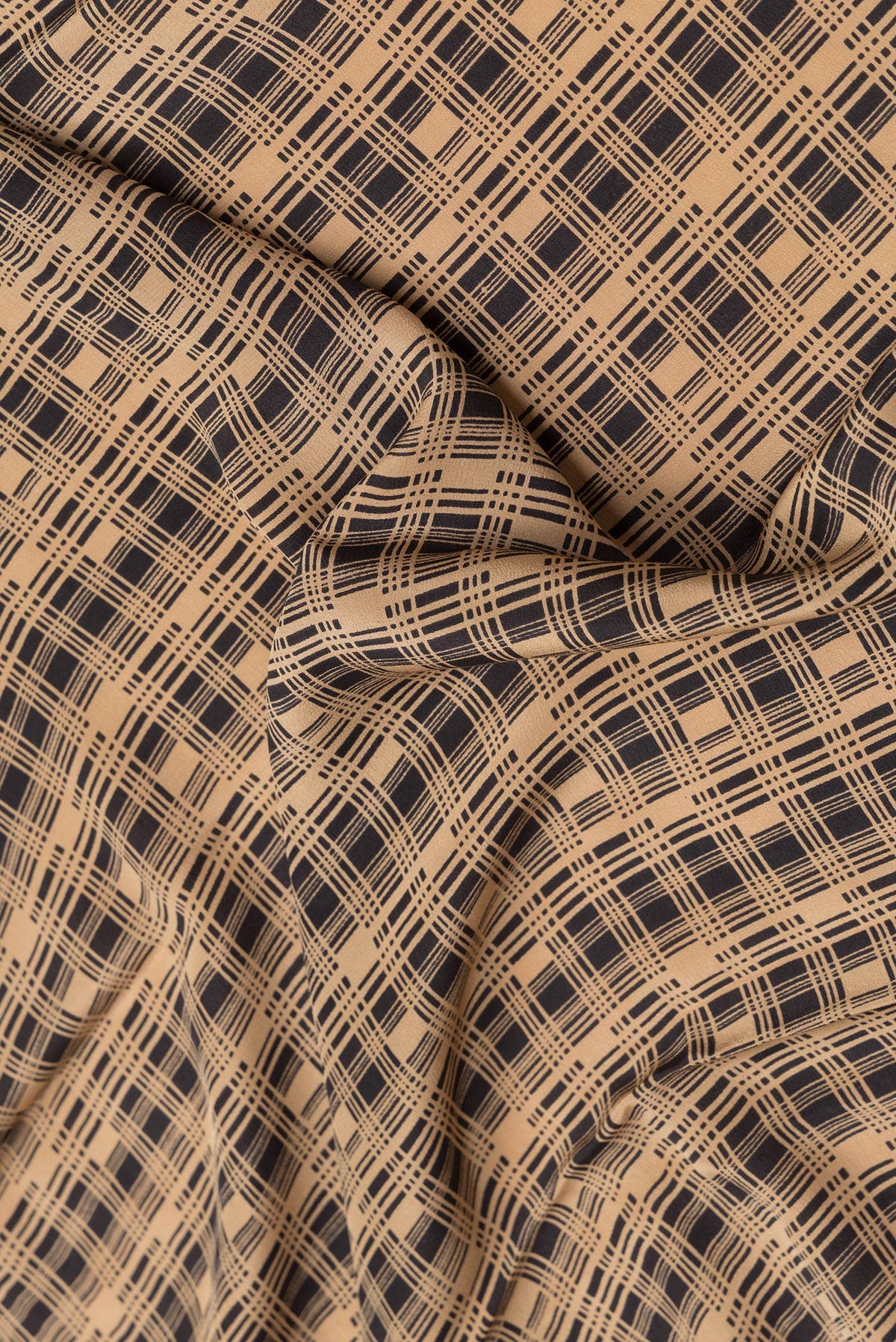 Close up of Black Dual Tone Mysore Crepe Saree with Printed design on the body and Printed Border.  displaying folds