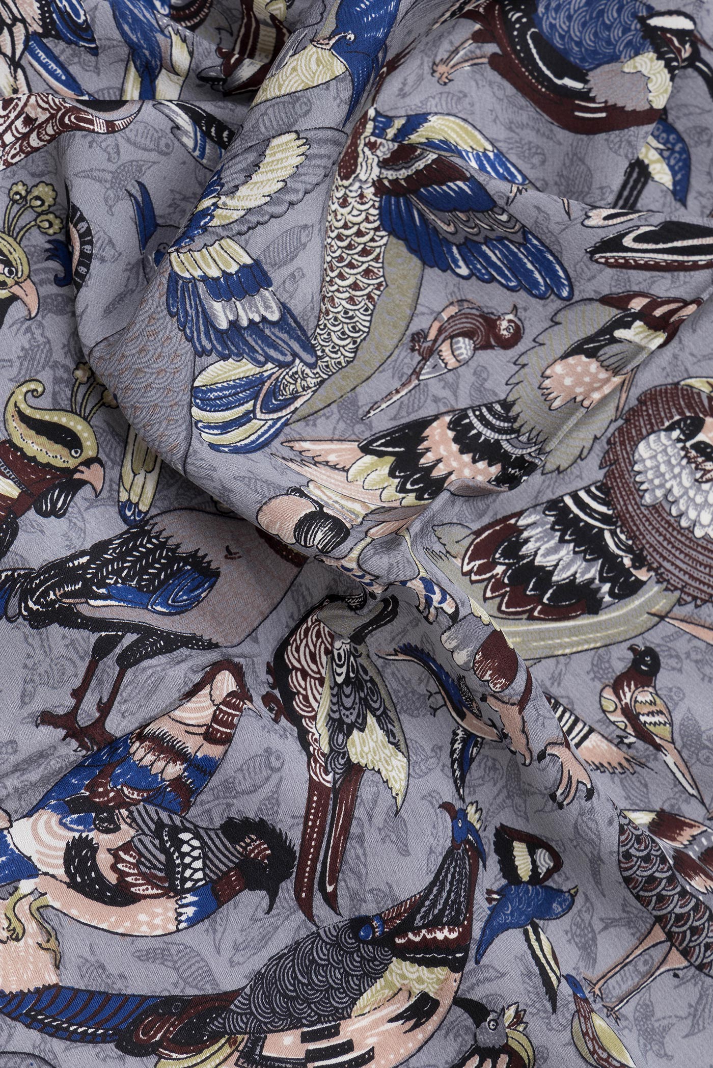 Close up of Grey Dual Tone Mysore Crepe Saree with Printed design on the body and Without Border.  displaying folds