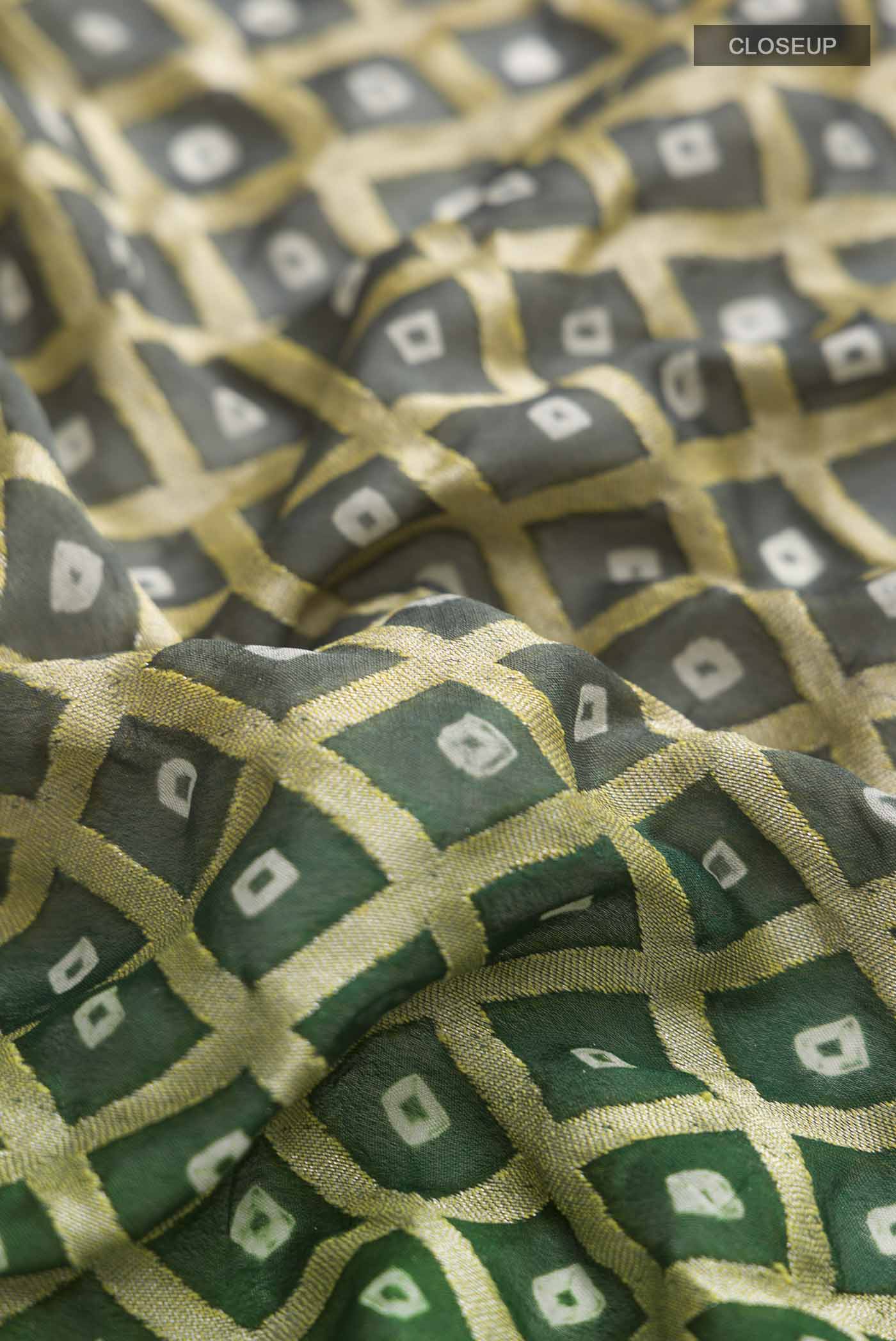 Close up of Green Banarasi Georgette Saree with Zari Butta on the body and Zari Border displaying folds