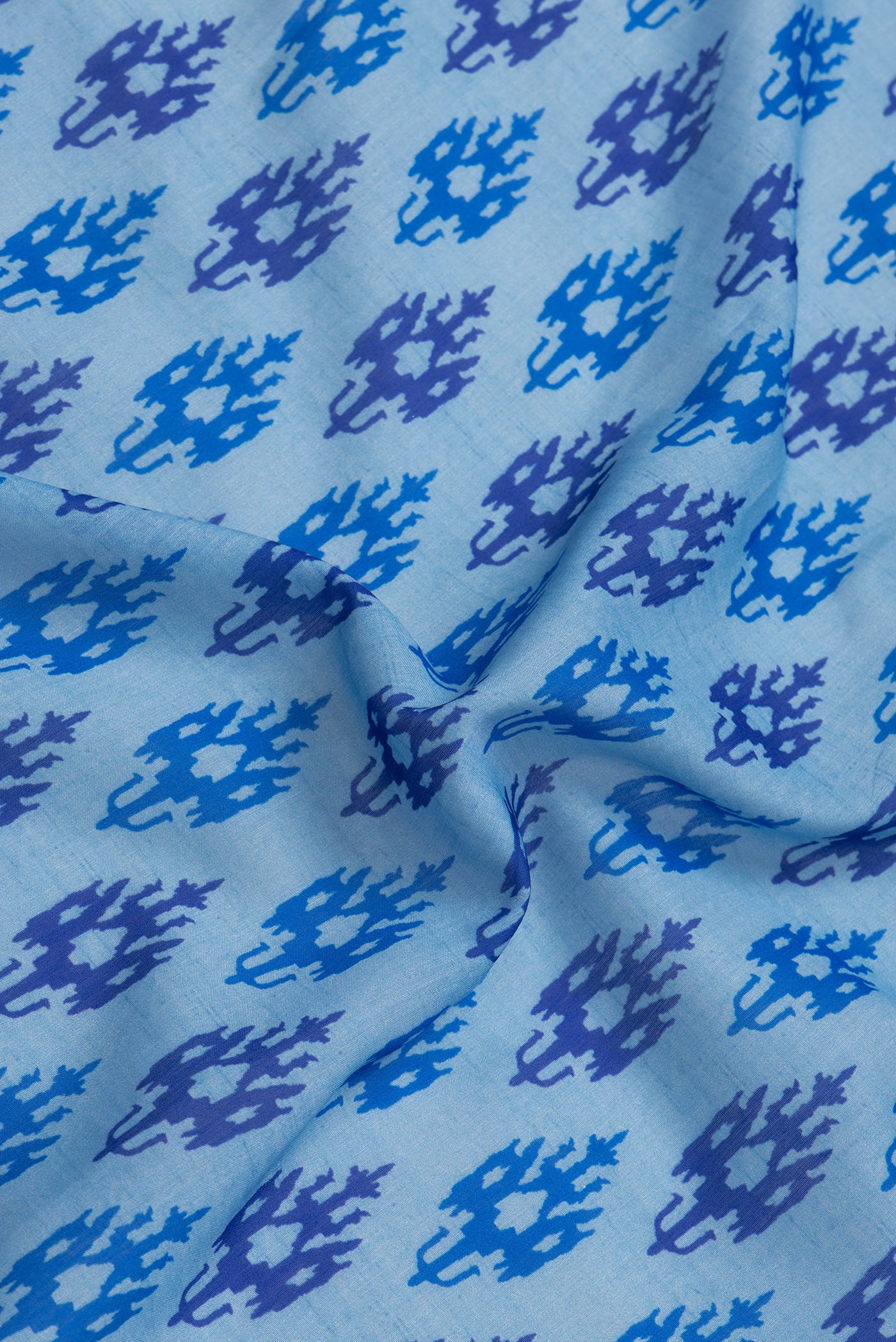 Close up of Sky Blue Dual Tone Tussar Silk Saree with Printed design on the body and Thread Border.  displaying folds