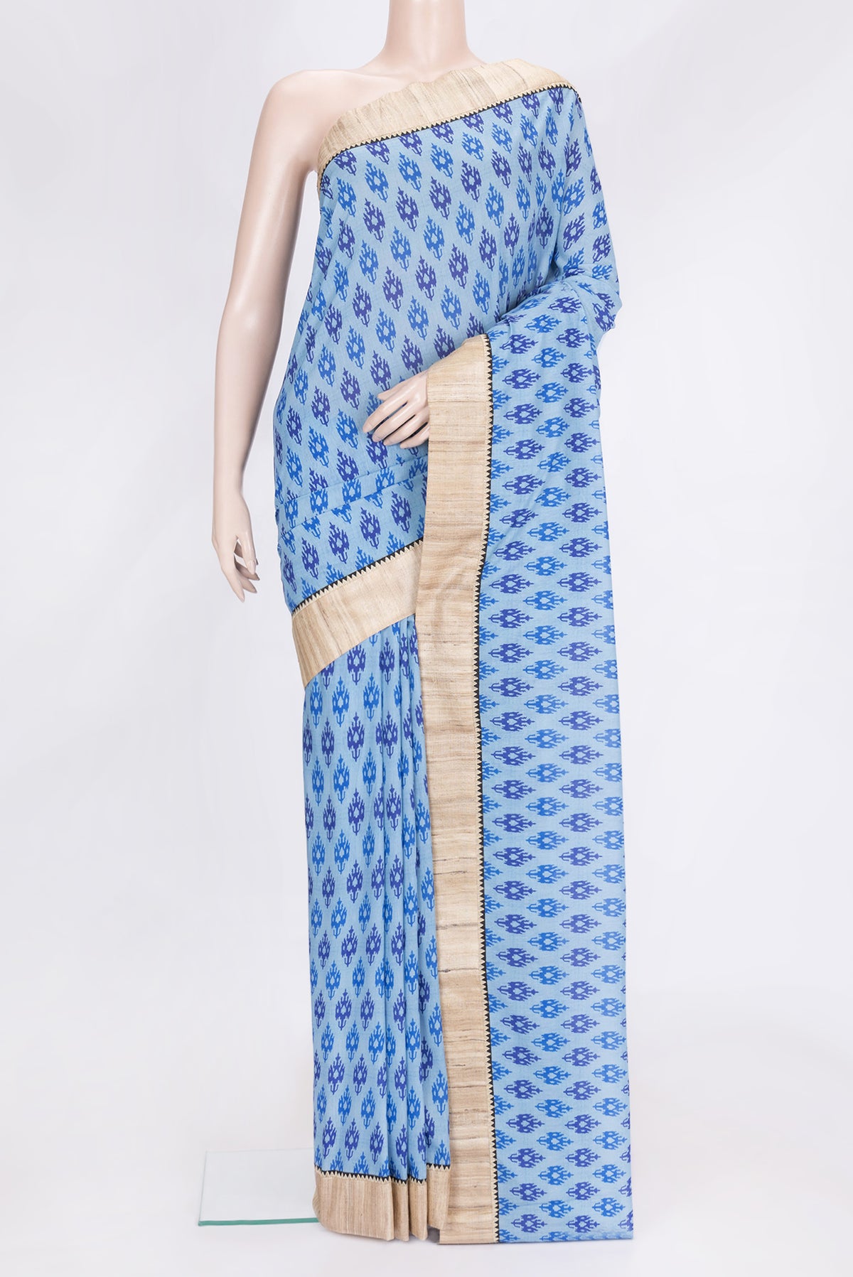 Sky Blue Dual Tone Tussar Silk Saree with Printed design on the body and Thread Border.  displayed on a mannequin
