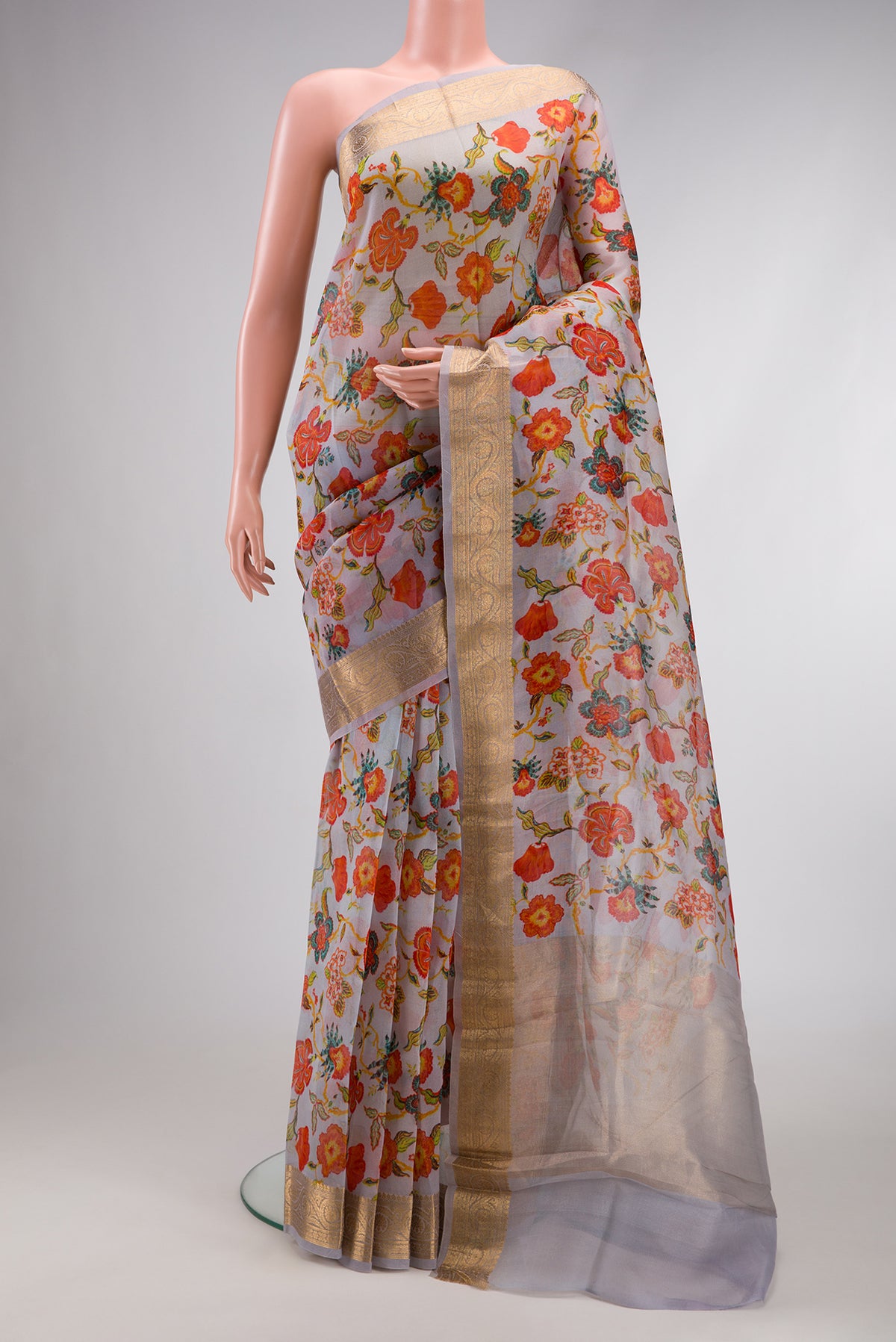 Grey Dual Tone Organza Silk Saree with Printed design on the body and Zari Border.  displayed on a mannequin