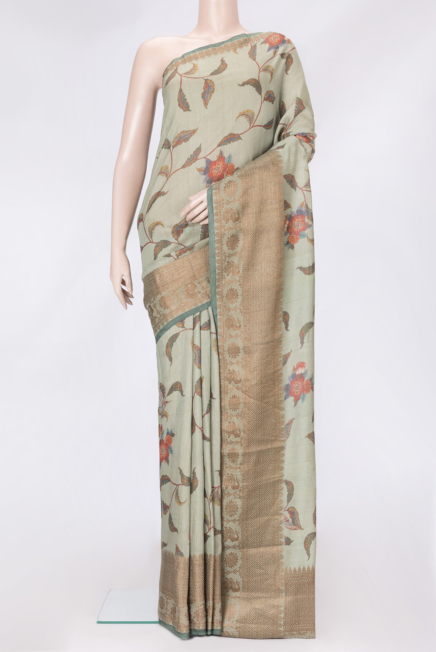 Pista Green Dual Tone Tussar Silk Saree with Printed design on the body and Thread Border.  displayed on a mannequin
