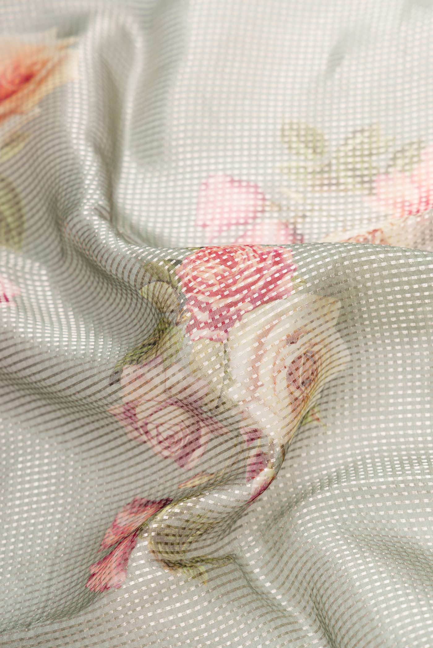 Close up of Light Green Dual Tone Organza Silk Saree with Stripes on the body and Without Border.  displaying folds
