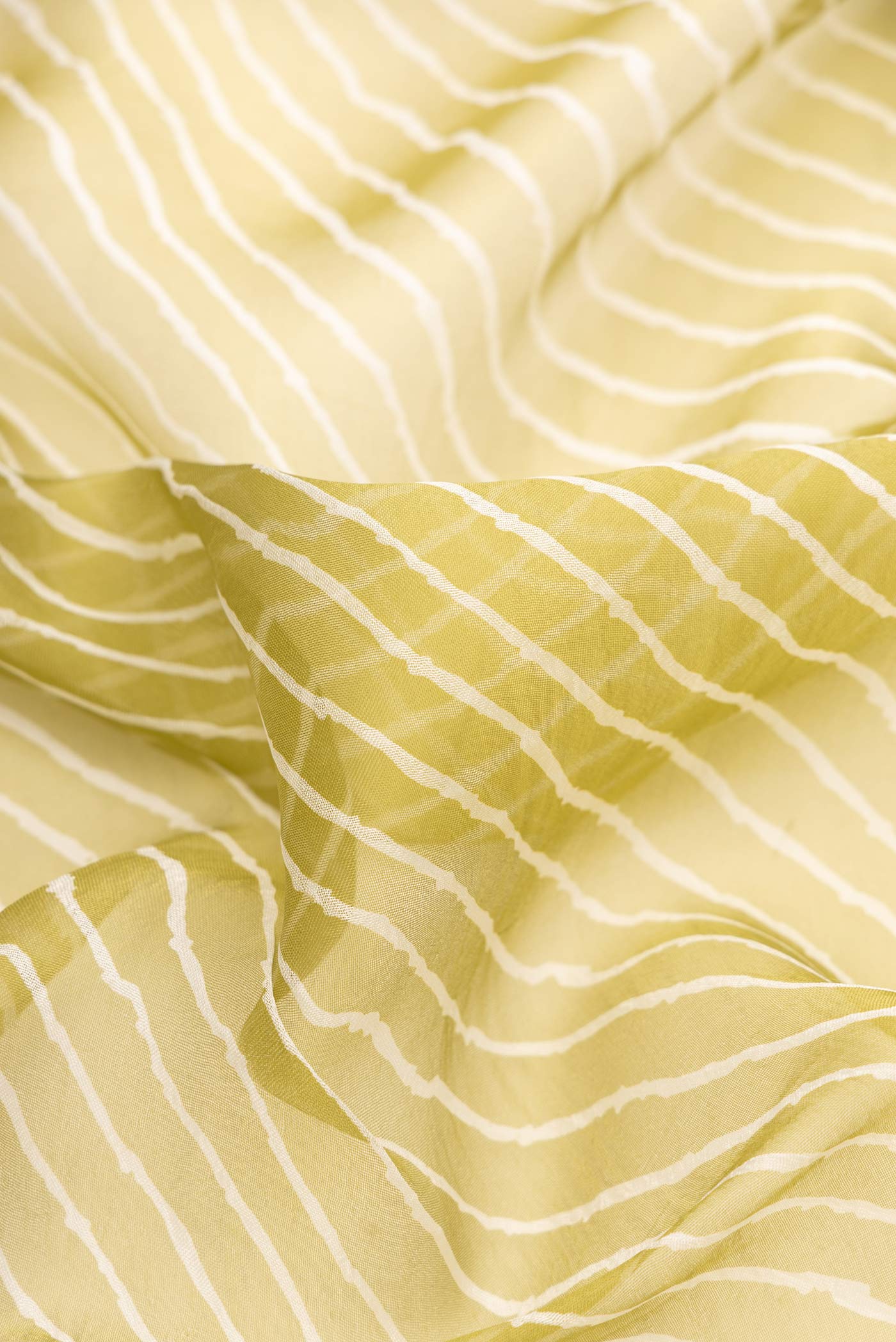 Close up of Mehandi Green Dual Tone Organza Silk Saree with Stripes on the body and Embroidery Border.  displaying folds