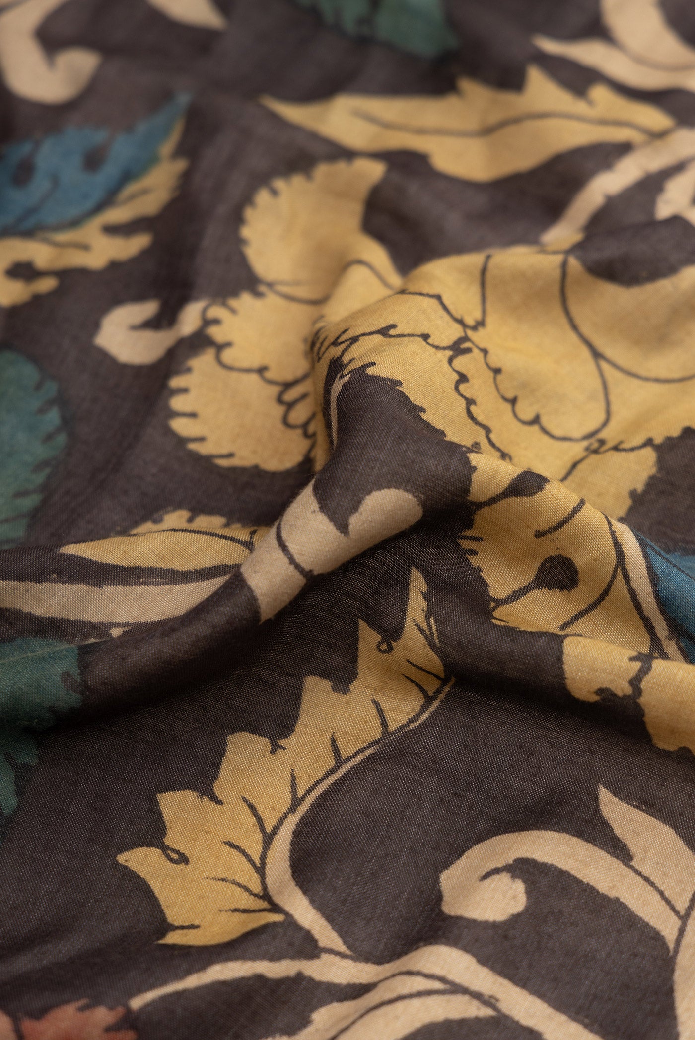 Close up of Brown Dual Tone Tussar Silk Saree with Printed design on the body and Printed Border.  displaying folds