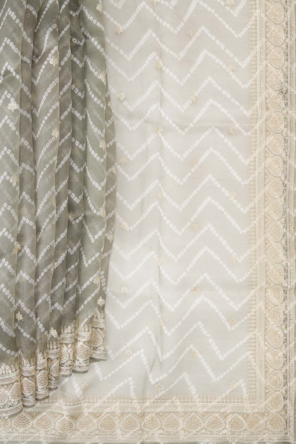 Pleats and pallu of Grey Dual Tone Organza Silk Saree with Printed design on the body and Embroidery Border. 