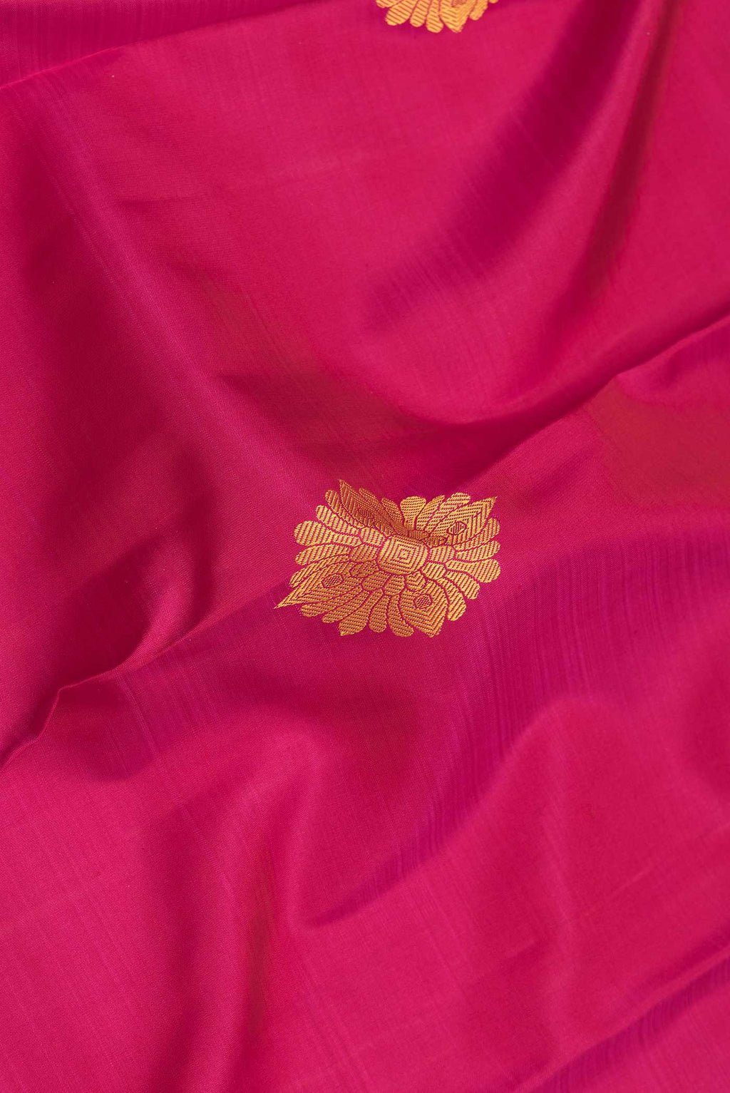 Close up of Pink Dual Tone Kanjivaram Saree with Thread Butta on the body and Thread Border.  displaying folds
