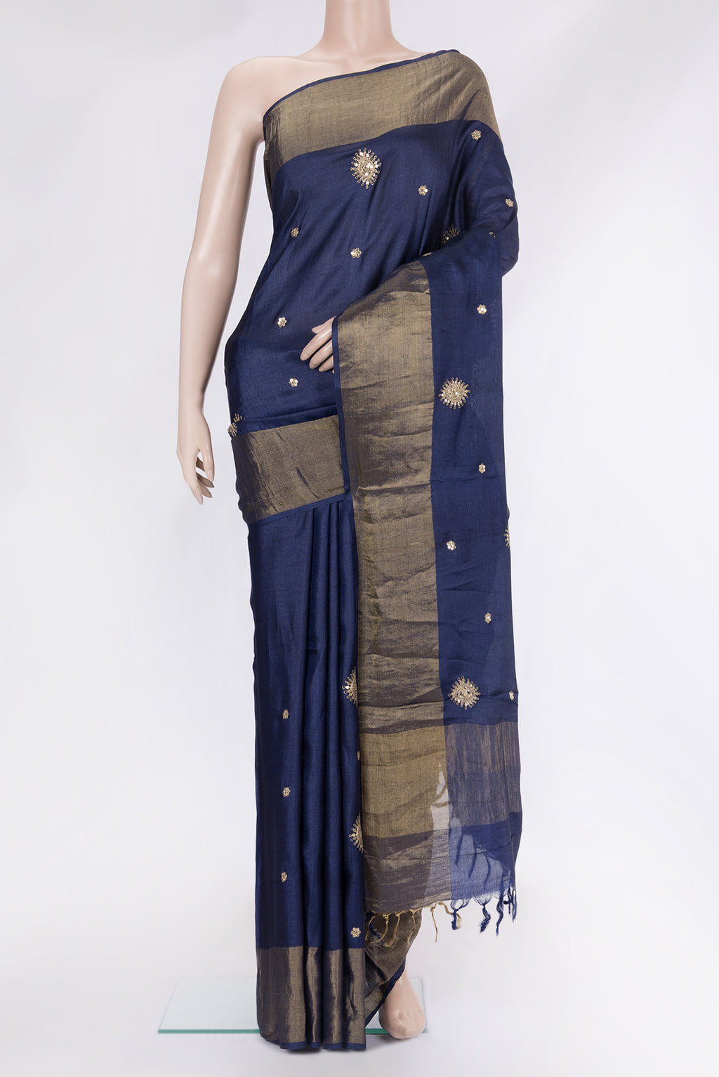Navy Blue Tussar Silk Saree with Embroidery on the body and Zari Border.  displayed on a mannequin