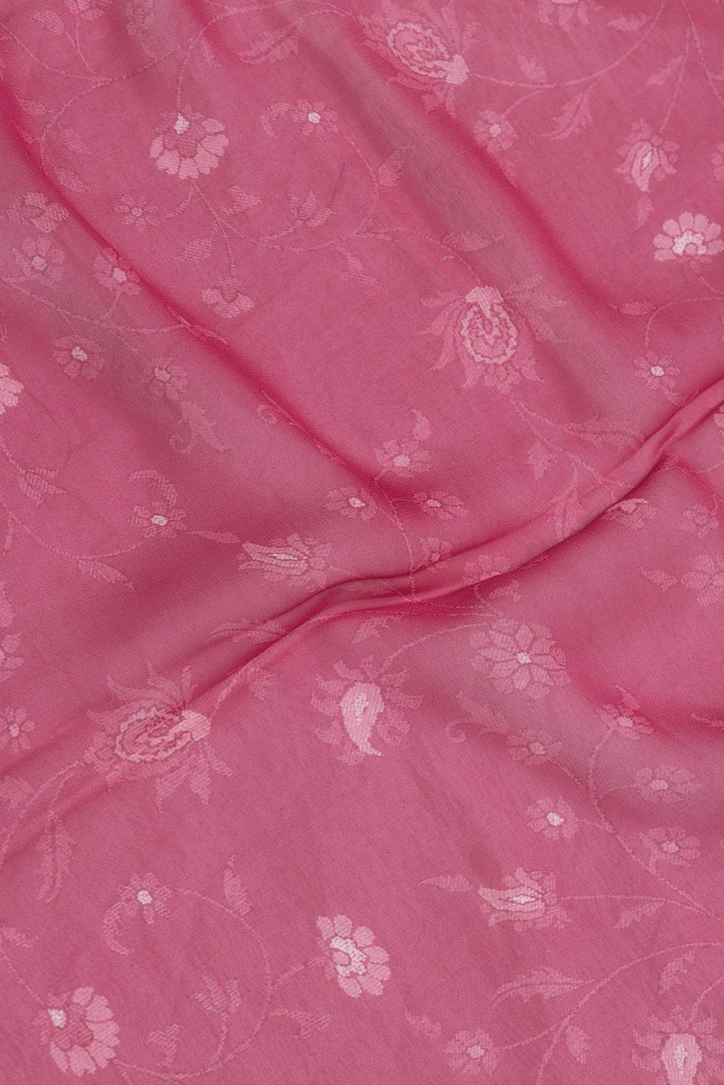 Close up of Pink Dual Tone Mysore Georgette Saree with Printed design on the body and Printed Border.  displaying folds