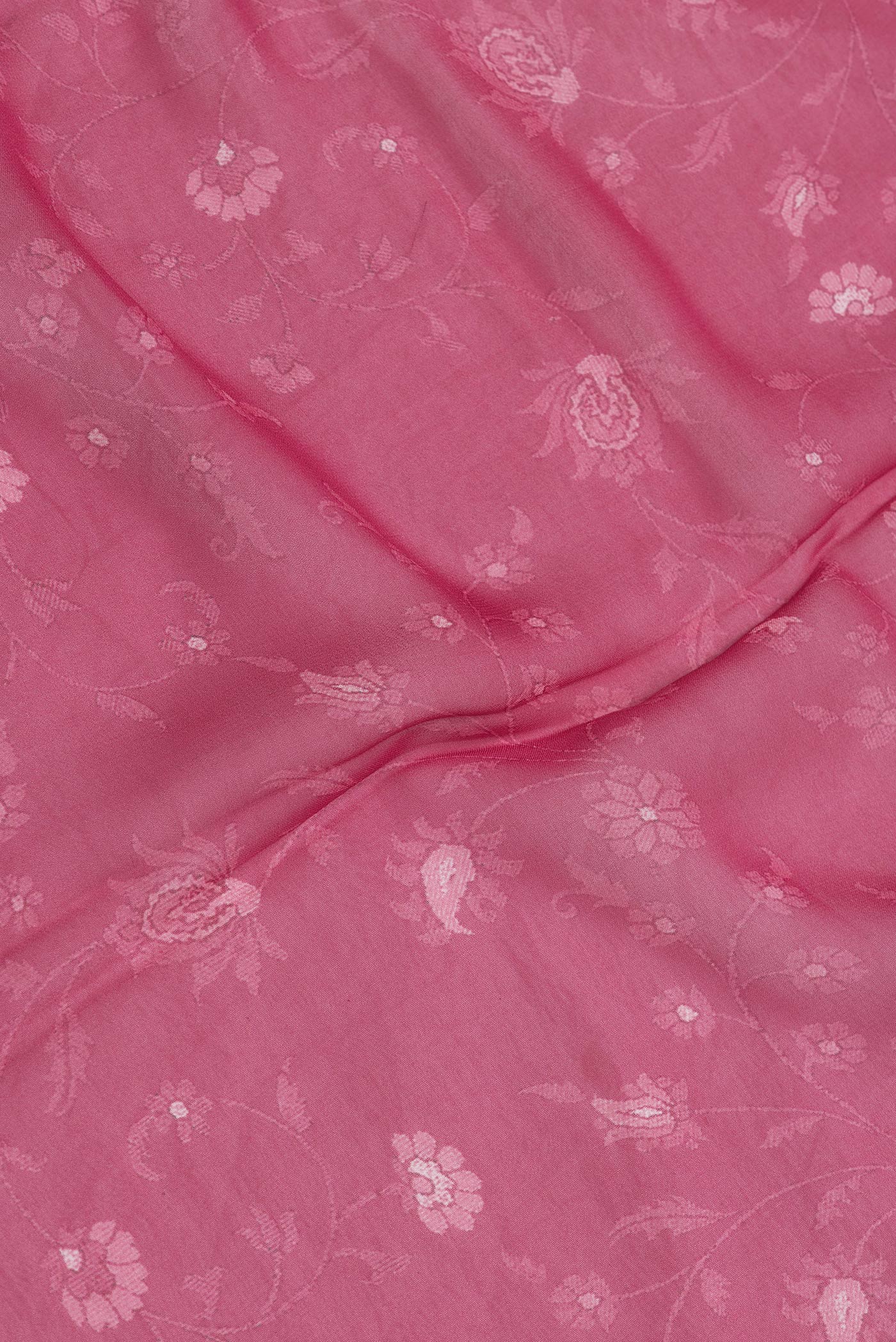 Close up of Pink Dual Tone Mysore Georgette Saree with Printed design on the body and Printed Border.  displaying folds