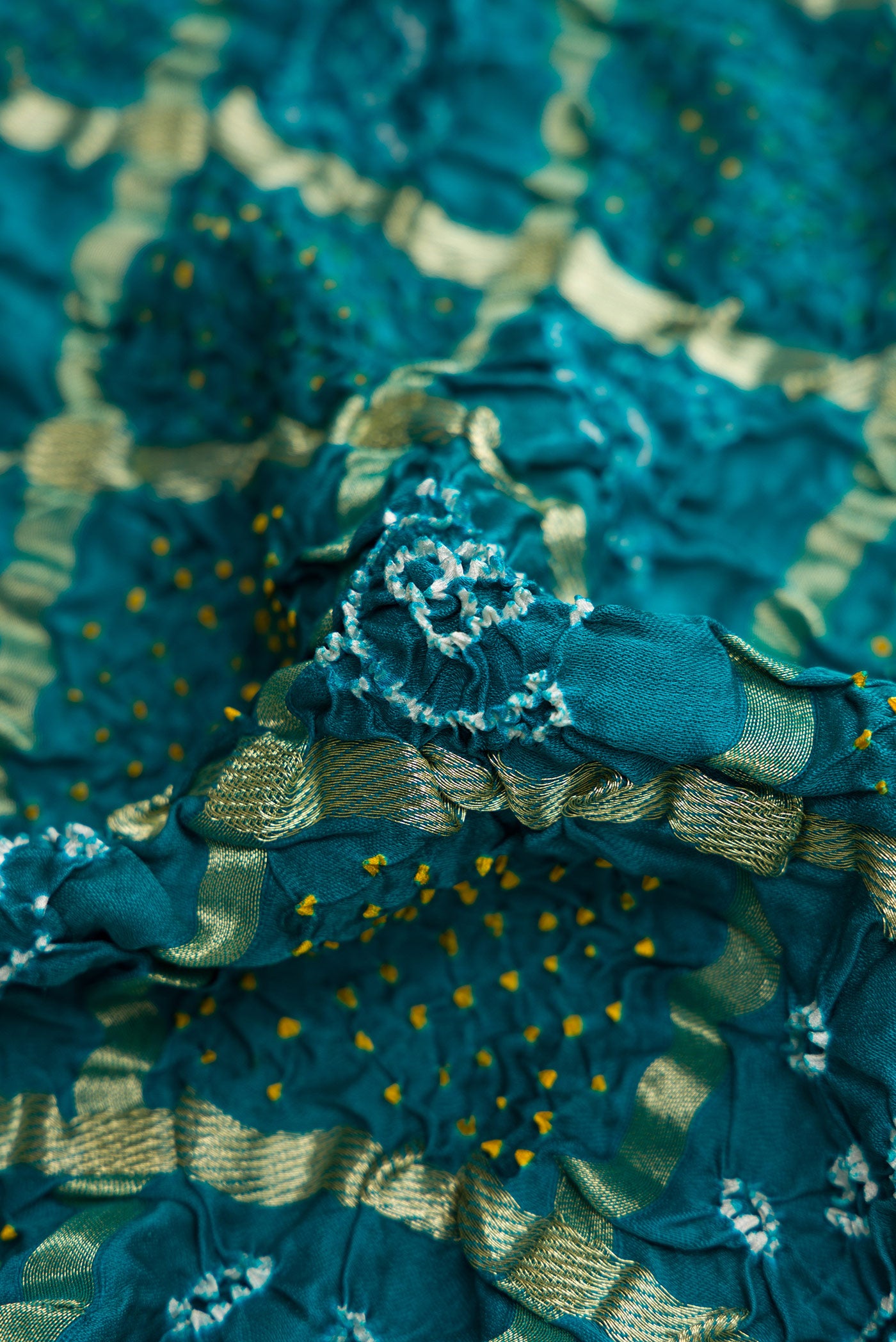 Close up of Green Dual Tone Bandhani Silk Saree with Bandhani Print on the body and Without Border.  displaying folds