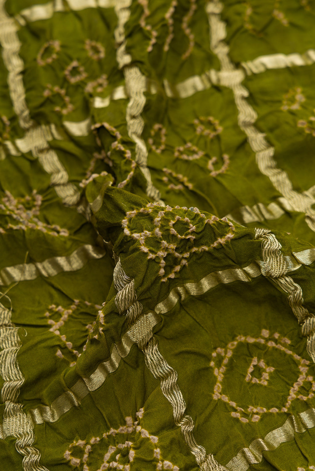Close up of Mehandi Green Dual Tone Bandhani Silk Saree with Bandhani Print on the body and Without Border.  displaying folds
