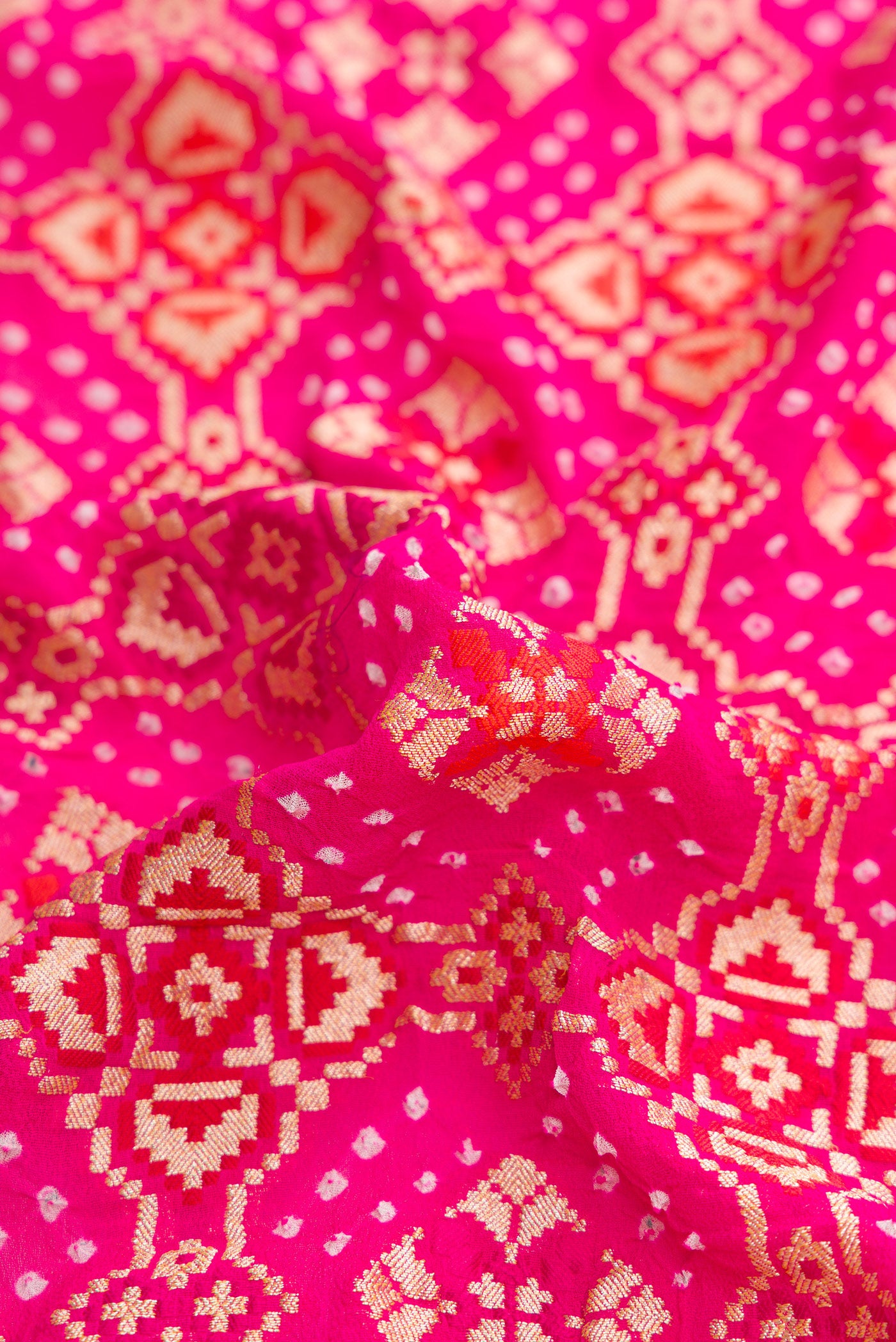 Close up of Dark Pink Dual Tone Banarasi Georgette Saree with Zari Brocade on the body and Zari Border.  displaying folds