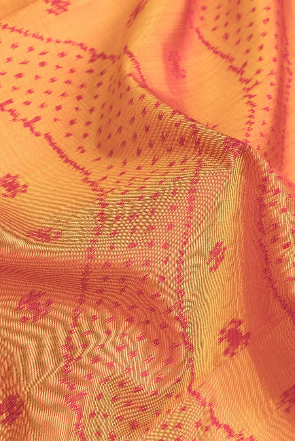 Close up of Mustard Dual Tone Rajkot Patola Silk Saree with Ikat Print on the body and Zari Border.  displaying folds