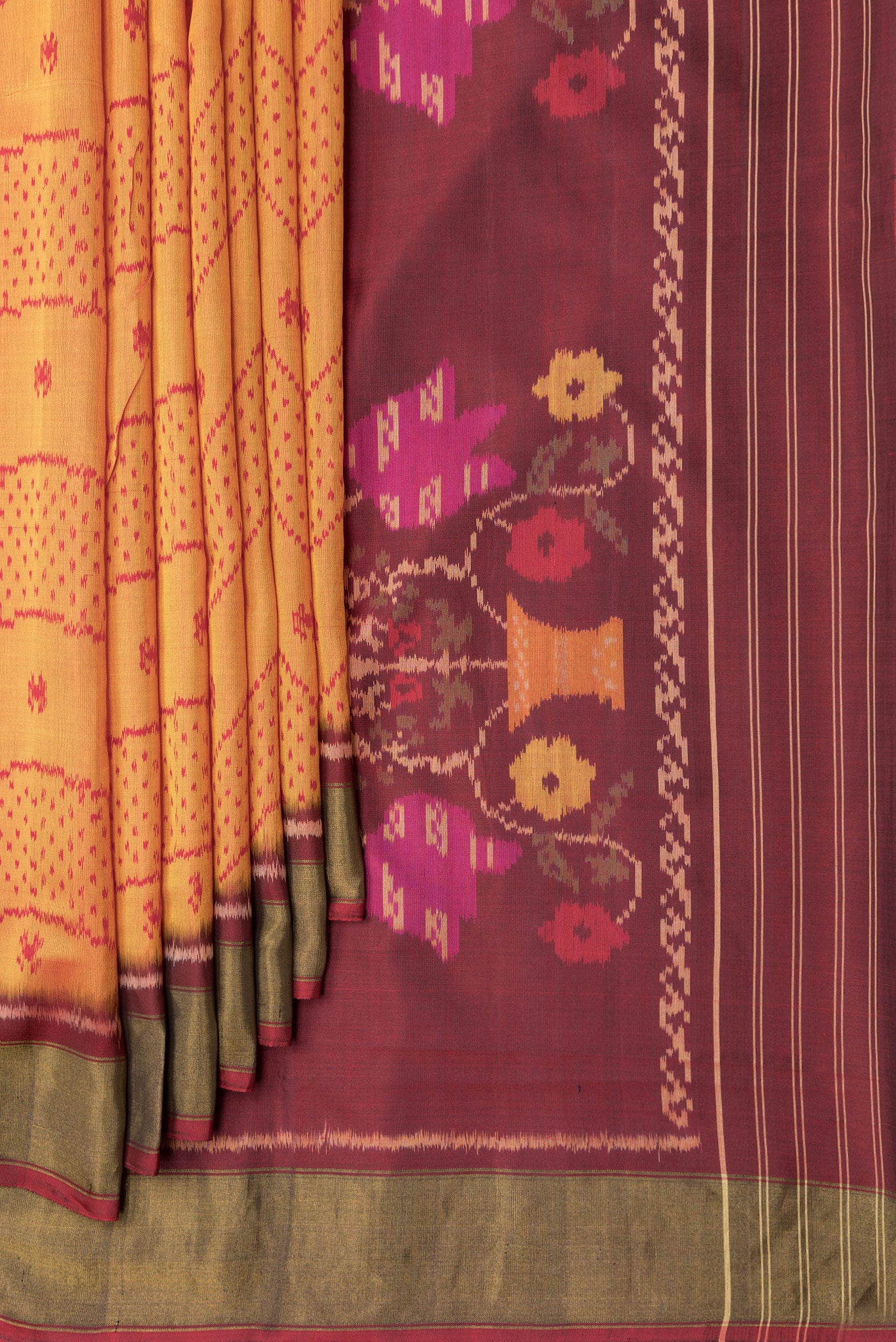 Pleats and pallu of Mustard Dual Tone Rajkot Patola Silk Saree with Ikat Print on the body and Zari Border. 