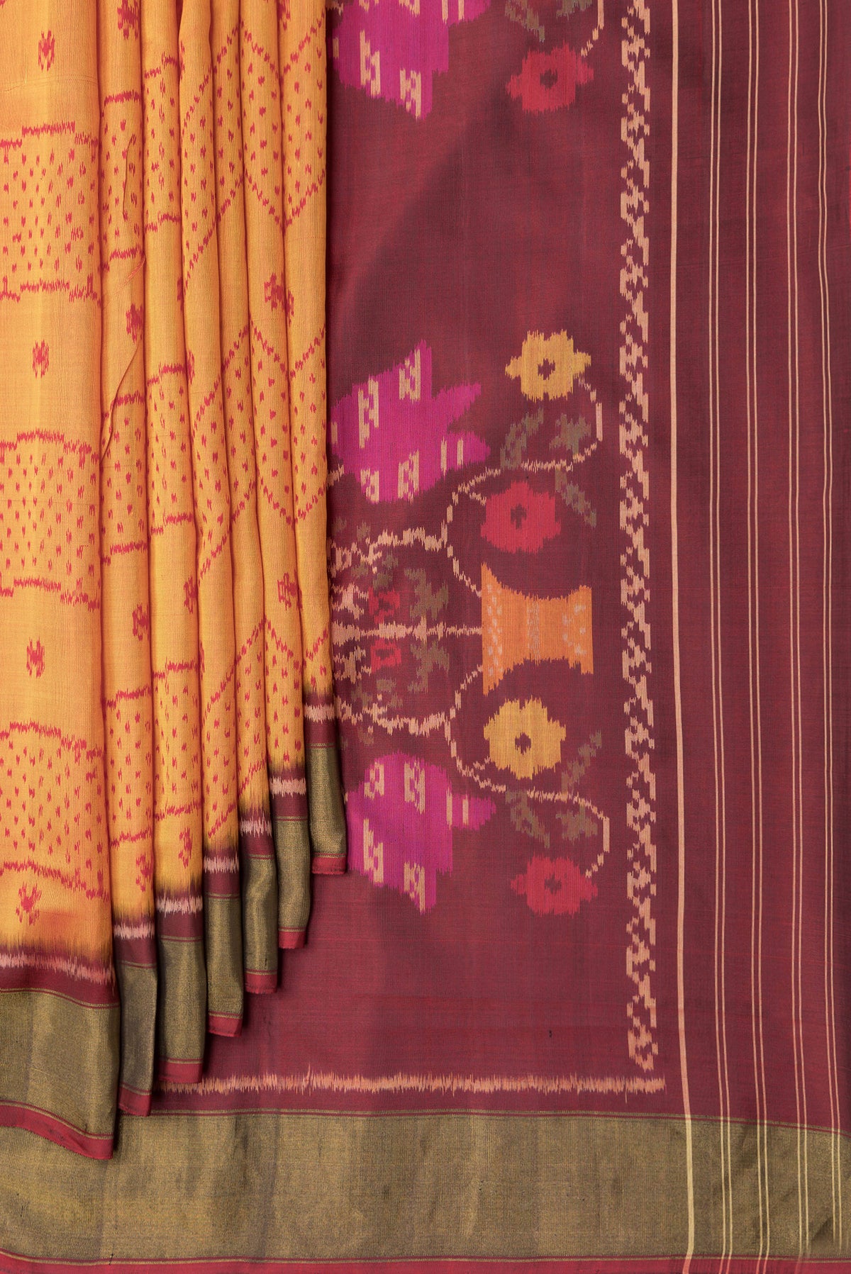 Pleats and pallu of Mustard Dual Tone Rajkot Patola Silk Saree with Ikat Print on the body and Zari Border. 