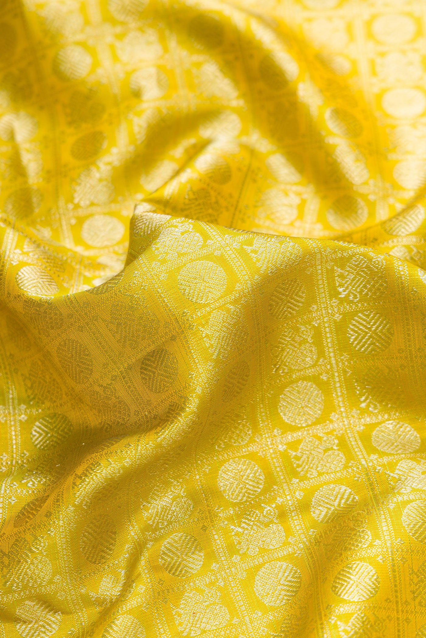Close up of Parrot Green Dual Tone Kanjivaram Silk Saree with Zari Brocade on the body and Zari Border.  displaying folds