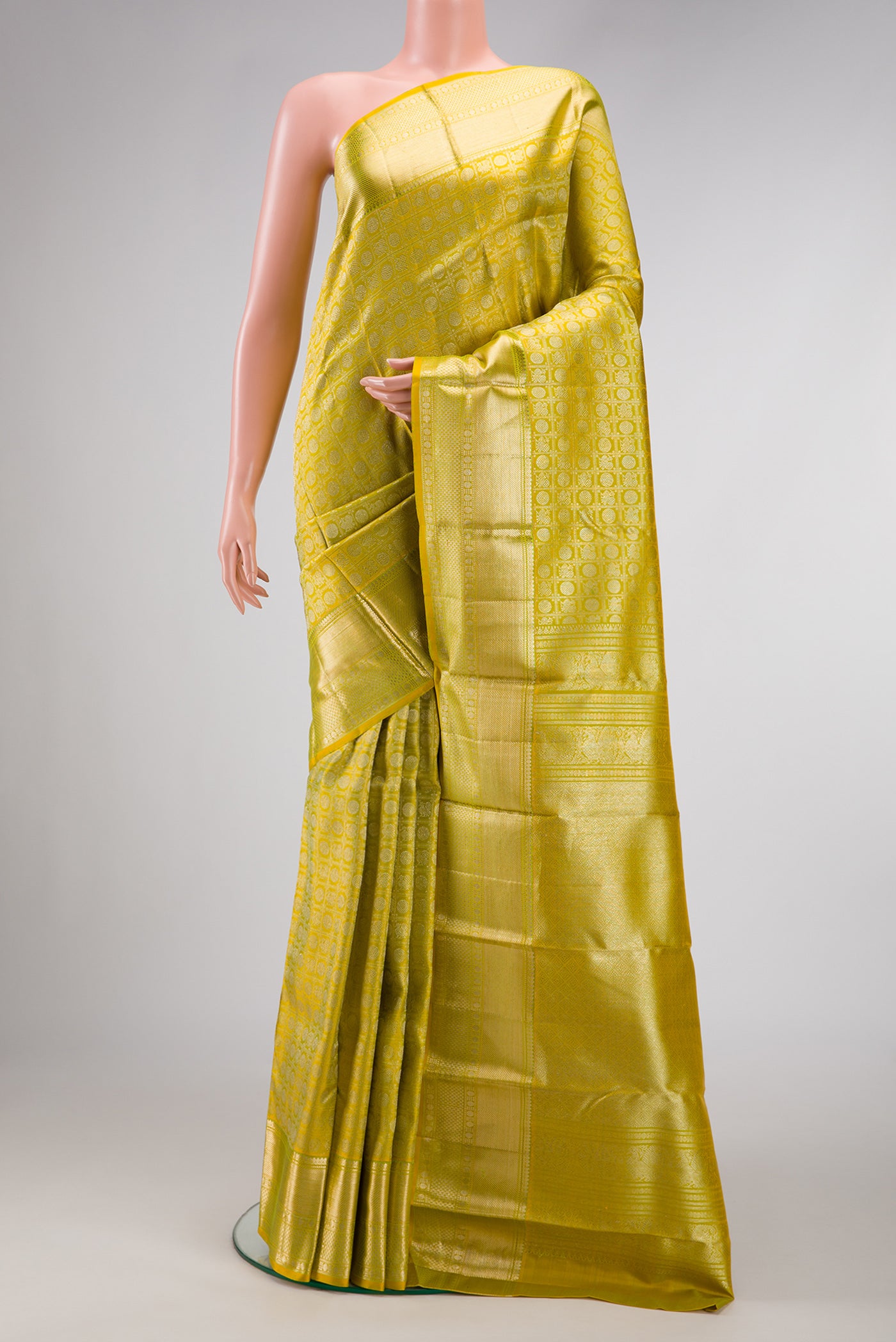 Parrot Green Dual Tone Kanjivaram Silk Saree with Zari Brocade on the body and Zari Border.  displayed on a mannequin