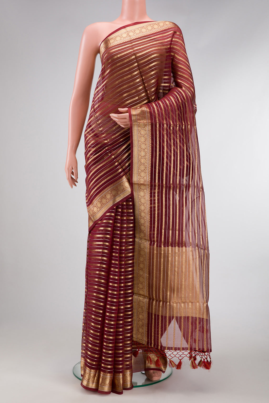 Maroon Dual Tone Organza Silk Saree with Stripes on the body and Zari Border.  displayed on a mannequin
