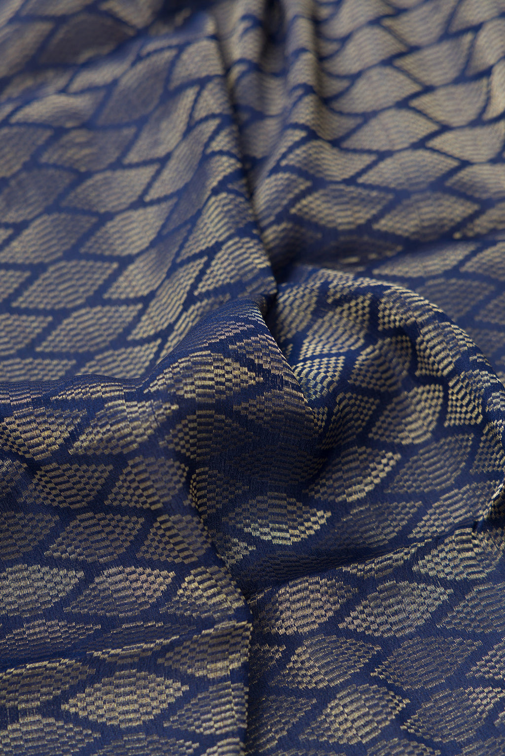 Close up of Royal Blue Dual Tone Georgette Saree with Zari Brocade on the body and Zari Border.  displaying folds