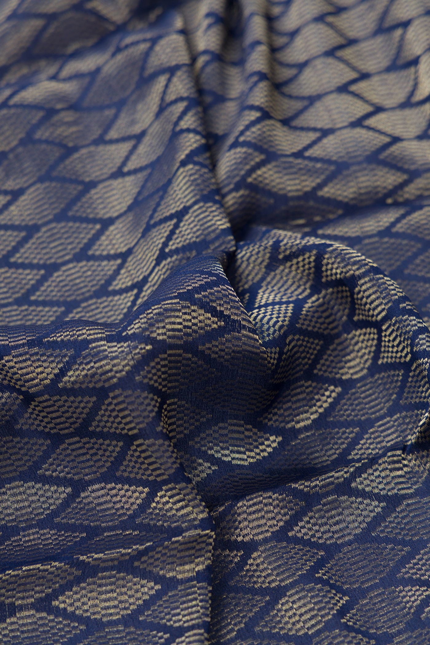 Close up of Royal Blue Dual Tone Georgette Saree with Zari Brocade on the body and Zari Border.  displaying folds