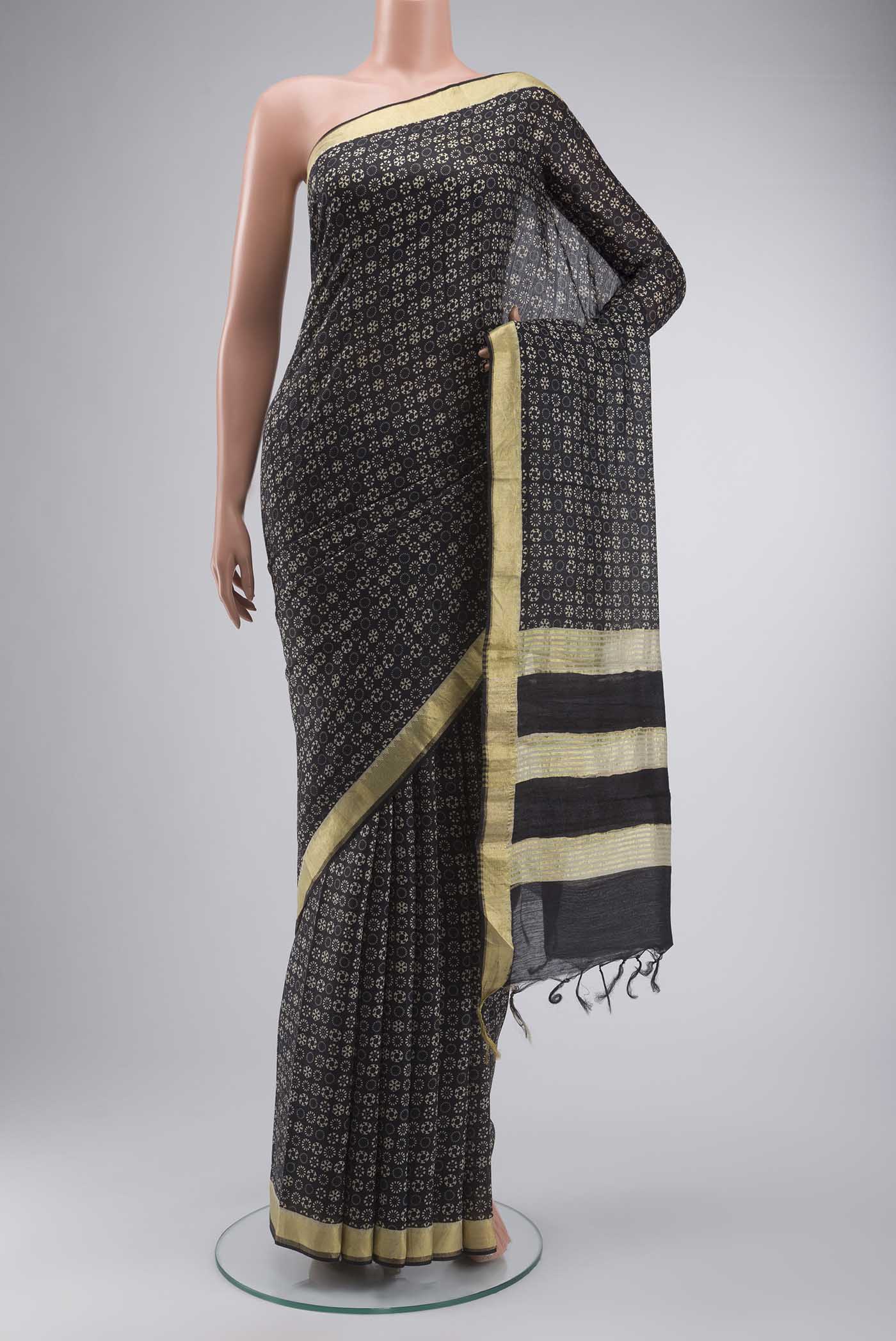 Black Tussar Silk Saree with Printed design on the body and Zari Border displayed on a mannequin