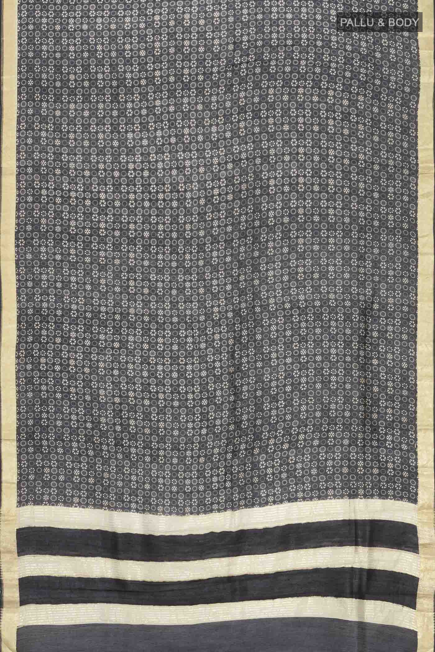 Flat view of Black Tussar Silk Saree with Printed design on the body and Zari Border