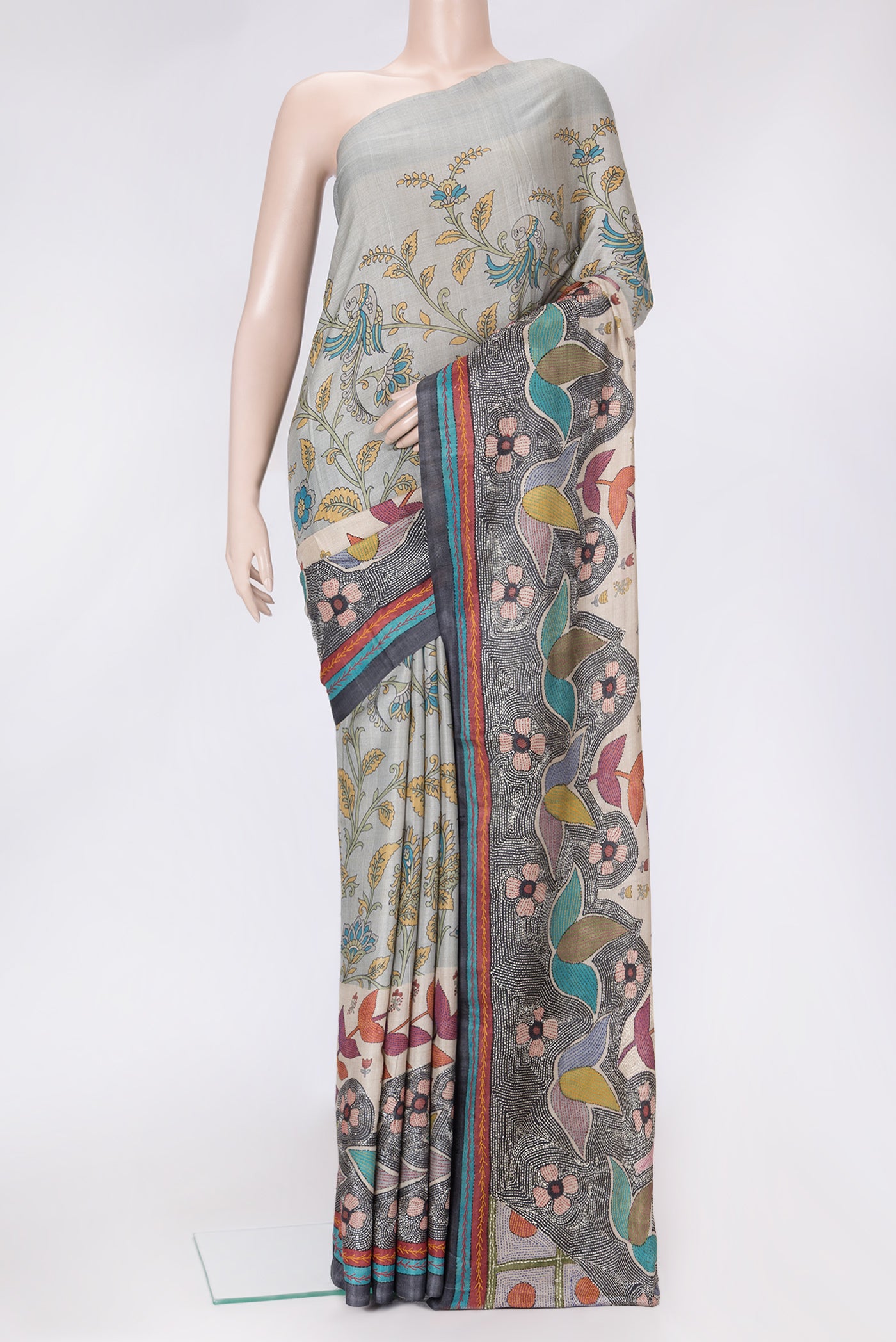 Grey Dual Tone Tussar Silk Saree with Printed design on the body and Embroidery Border.  displayed on a mannequin