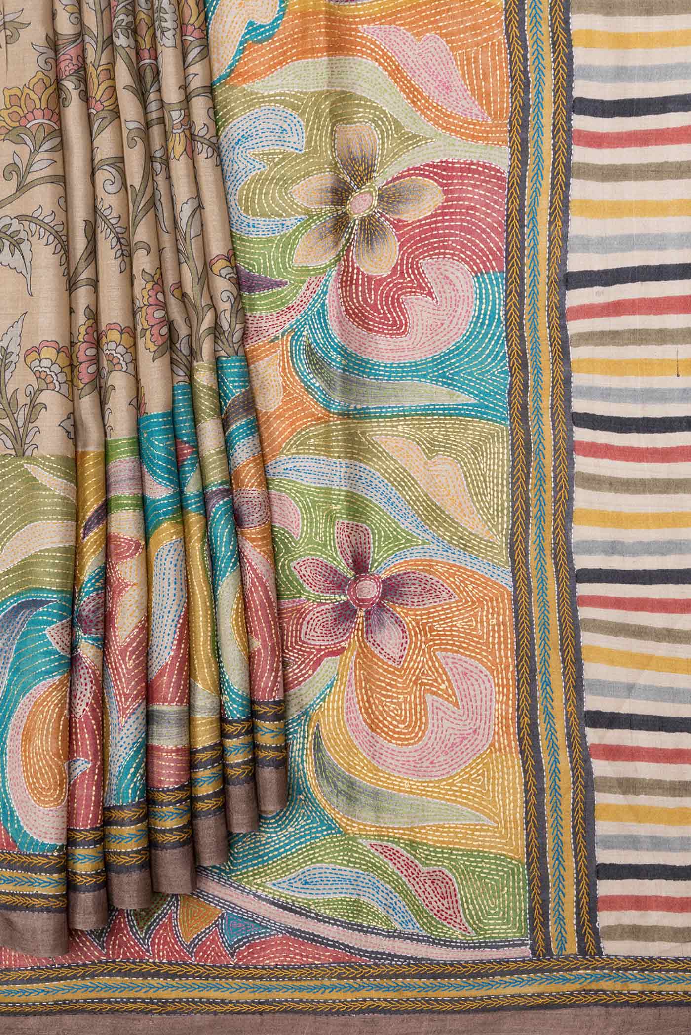 Pleats and pallu of Beige Dual Tone Tussar Saree with Printed design on the body and Embroidery Border. 