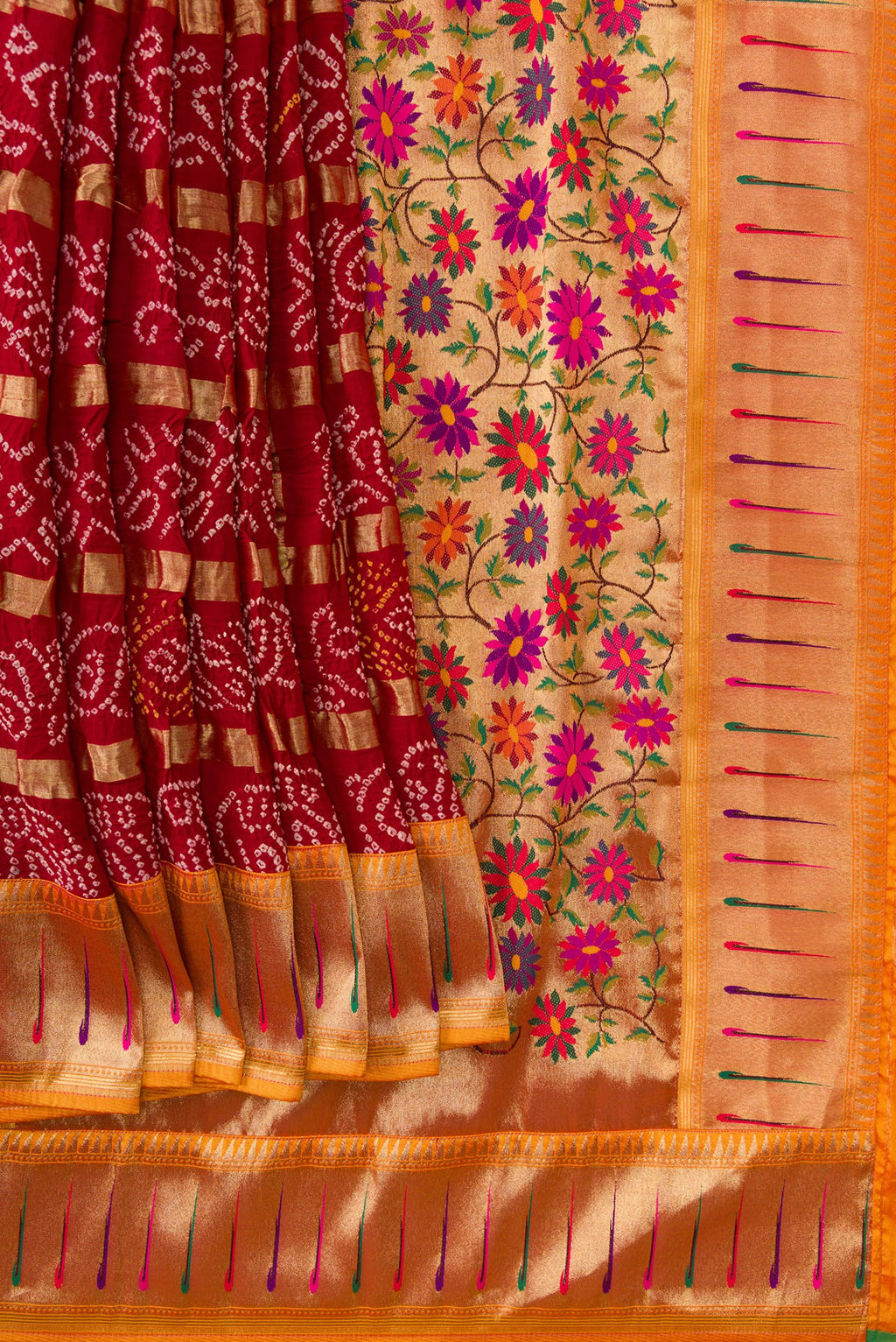Pleats and pallu of Maroon Dual Tone Bandhani Georgette Saree with Bandhani Print on the body and Paithani Border. 