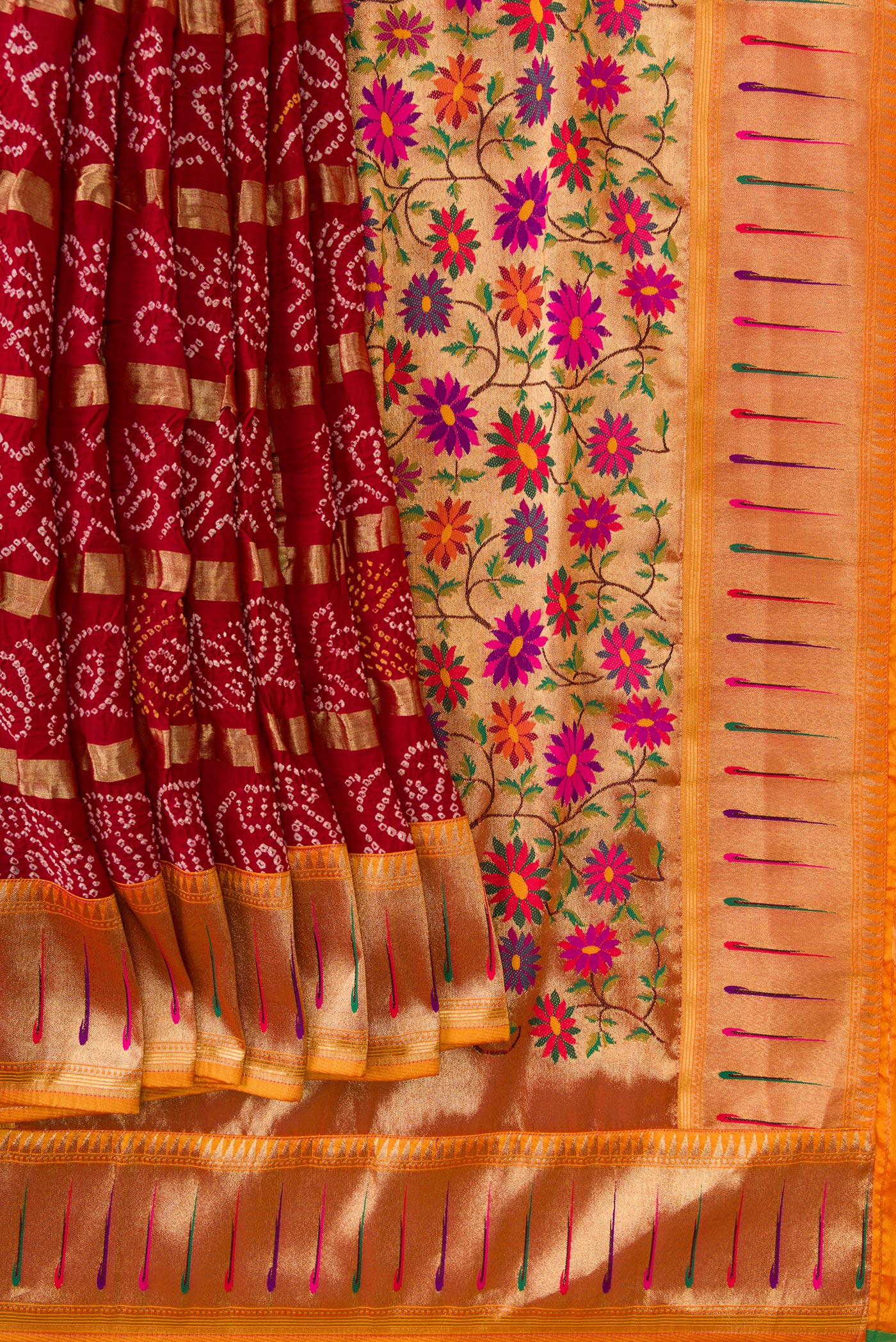 Pleats and pallu of Maroon Dual Tone Bandhani Georgette Saree with Bandhani Print on the body and Paithani Border. 