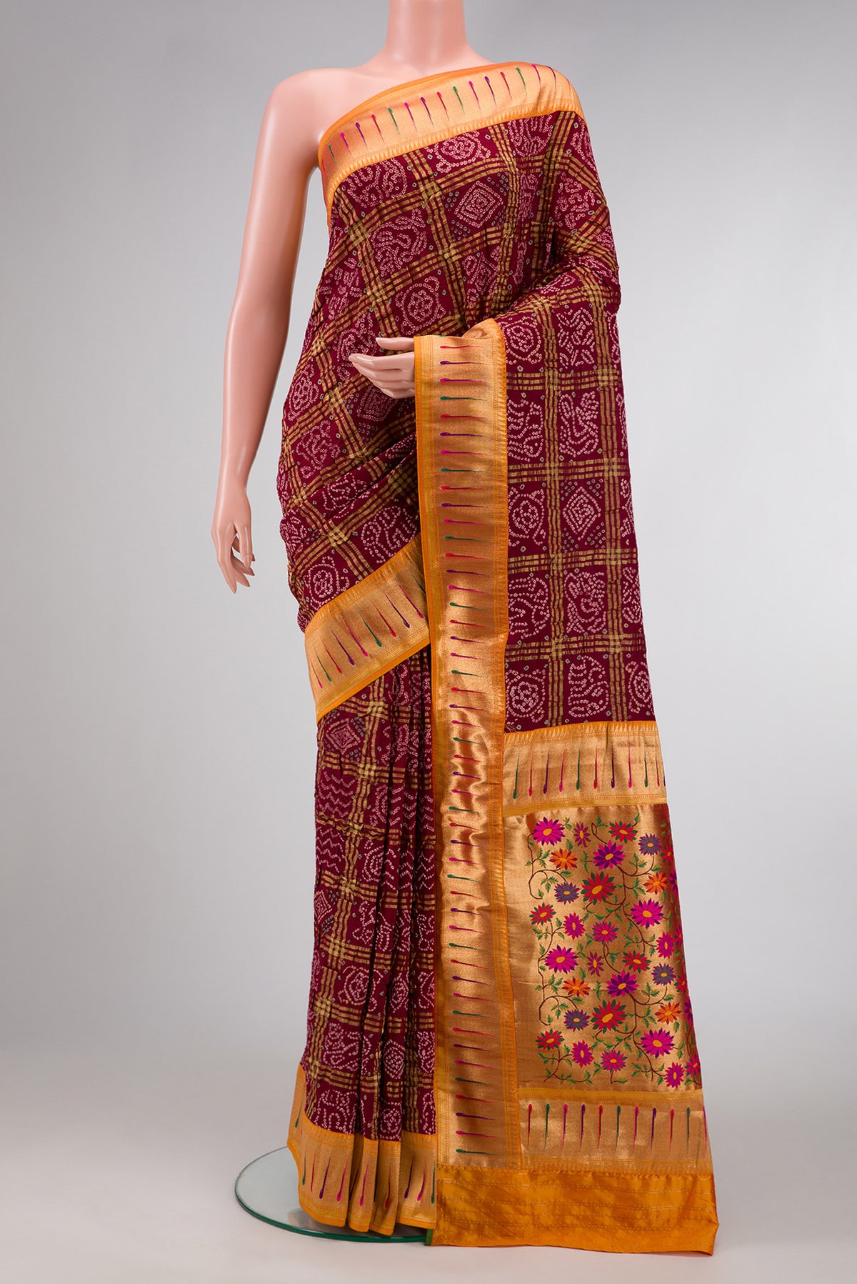 Maroon Dual Tone Bandhani Silk Saree with Bandhani Print on the body and Paithani Border.  displayed on a mannequin
